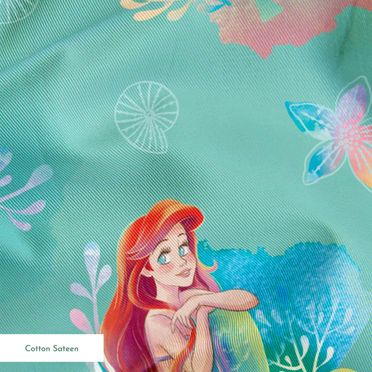 Whimsical teal pattern featuring mermaids with red hair, seashells, starfish, and coral in pastel colors springs sateen texture