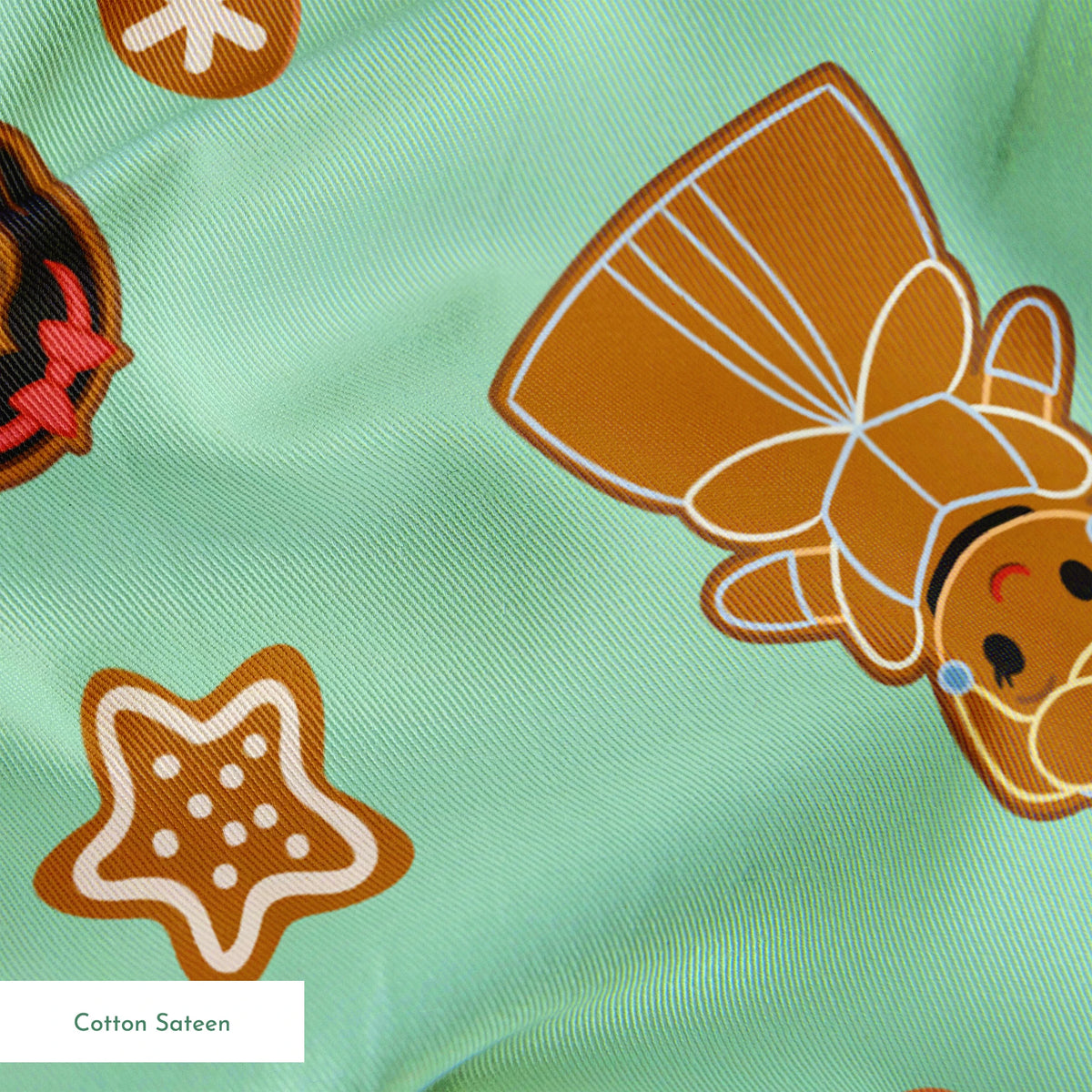 Disney Princess gingerbread cookies with star and snowflake designs on mint green background springs sateen texture