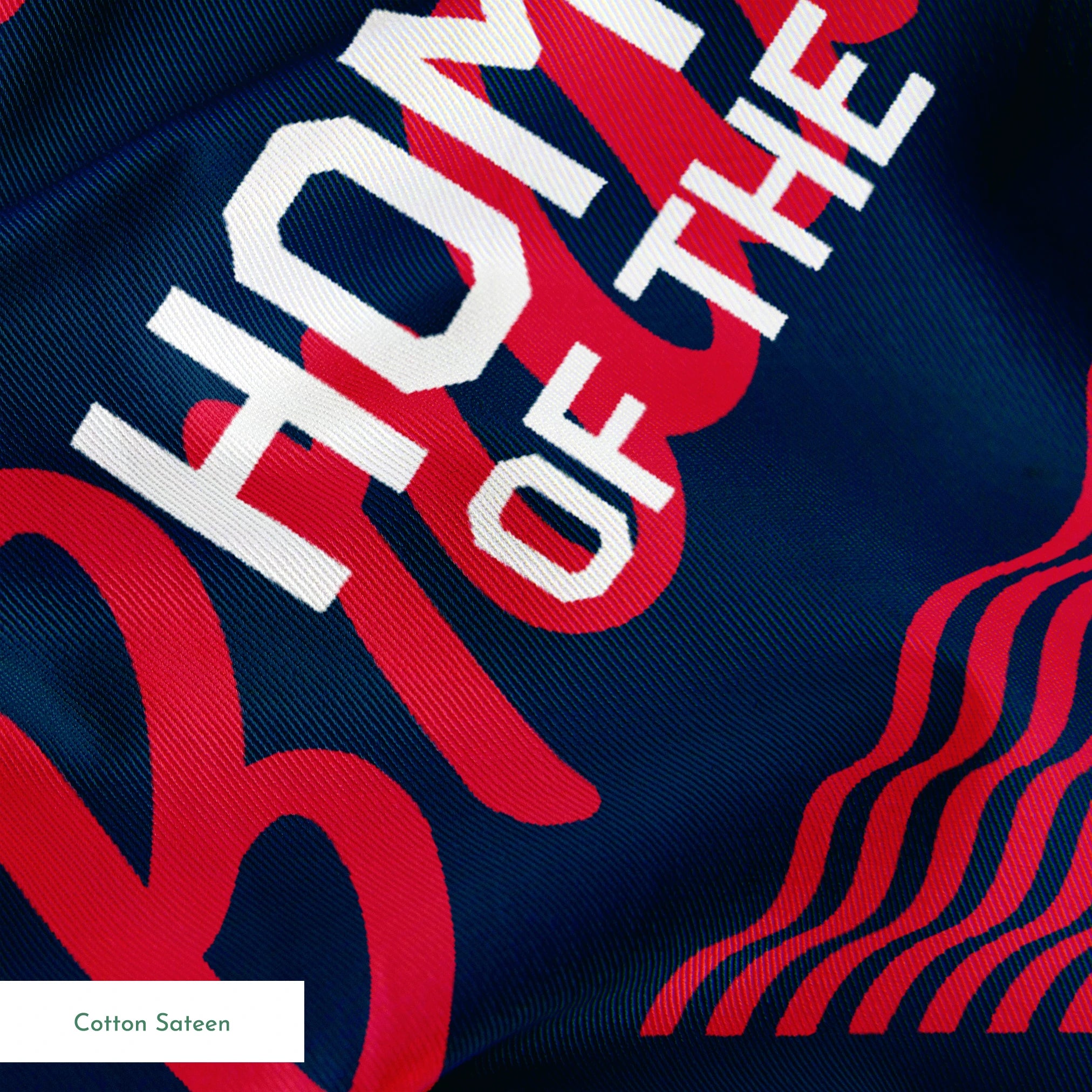 Repeating Peanuts "Home of the Brave" text pattern with bicycles on navy blue background with red wavy lines springs sateen texture