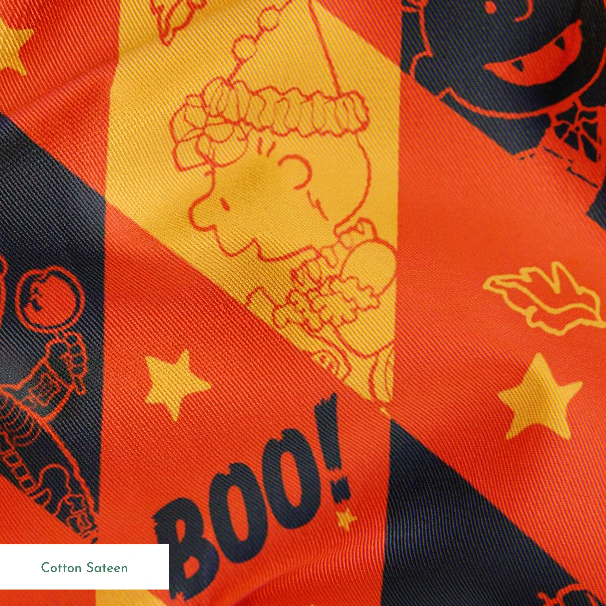Peanuts Halloween pattern with diamond shapes in orange, yellow, and black featuring Peanuts characters in costumes, webs, "BOO!" text, and seasonal decorations springs sateen texture