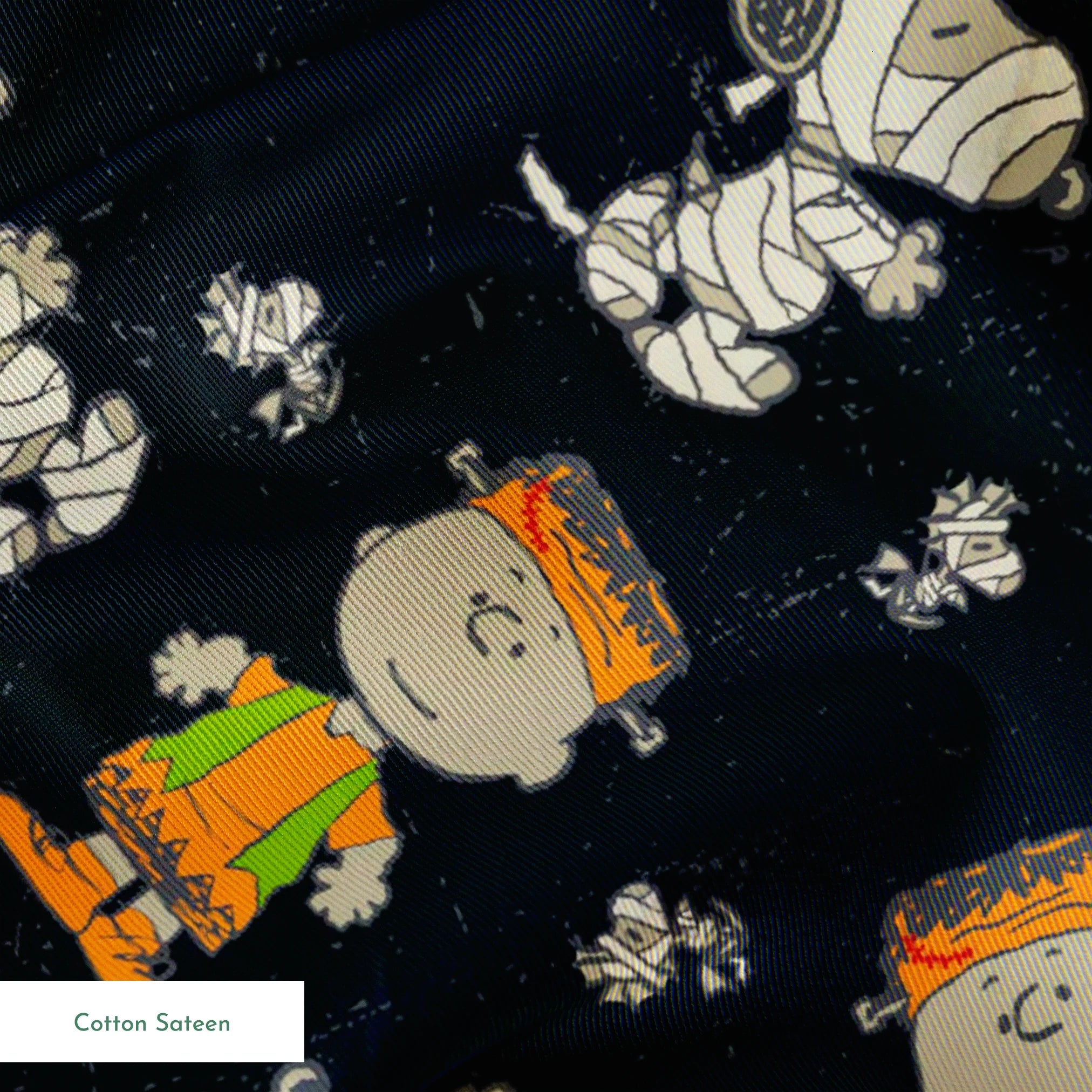 Peanuts characters pattern on black background featuring Snoopy and Charlie Brown in fall outfits springs sateen texture