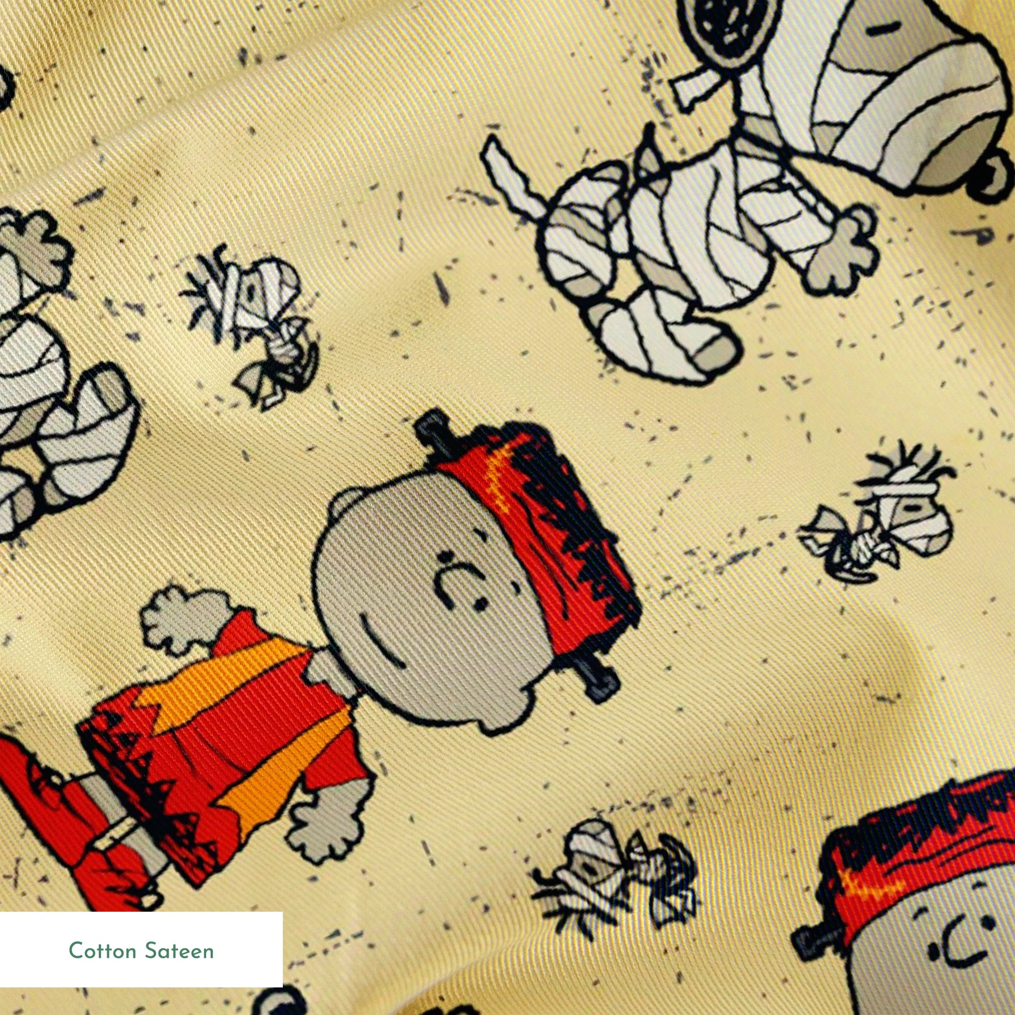 Peanuts characters pattern with Charlie Brown and Snoopy in halloween attire on beige background springs sateen texture