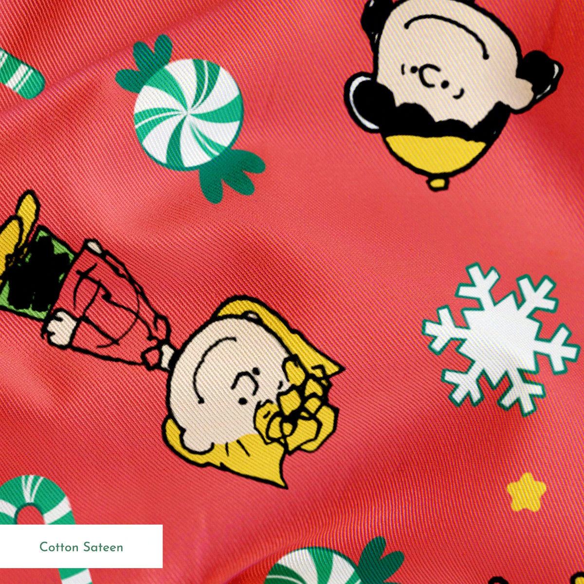 Festive Peanuts cartoon pattern with Charlie Brown characters, candy canes, snowflakes, and peppermints on red background springs sateen texture