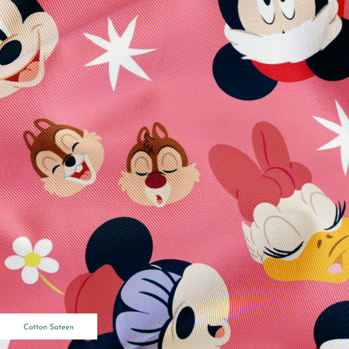 Mickey Mouse pattern with holiday elements on pink background, featuring white stars and gold accents springs sateen texture