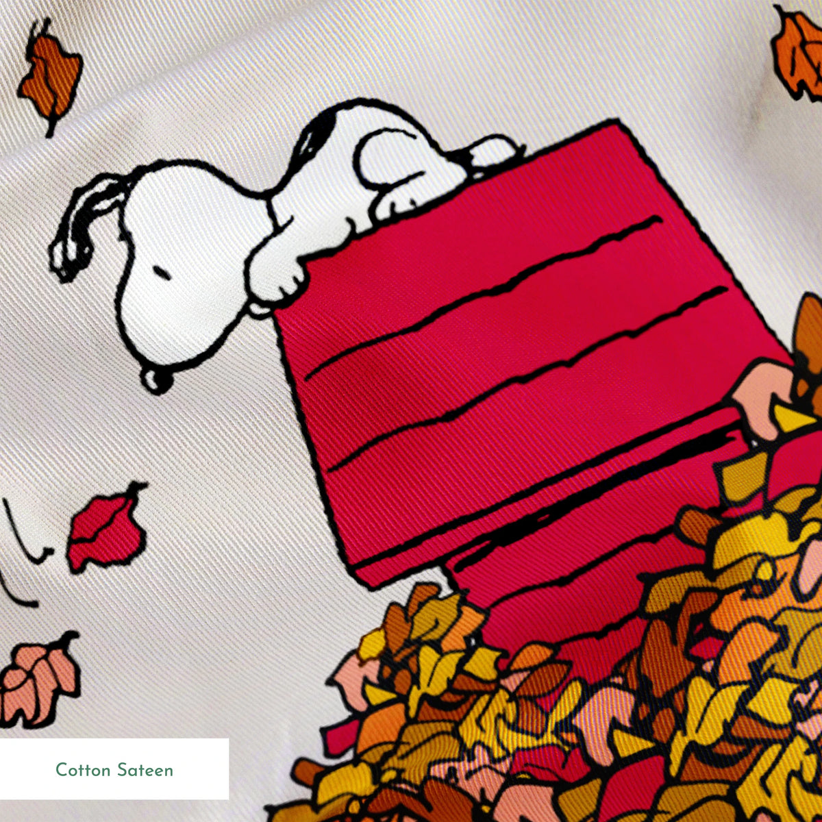Snoopy and red doghouse on colorful autumn leaf piles with falling leaves pattern on beige background springs sateen texture