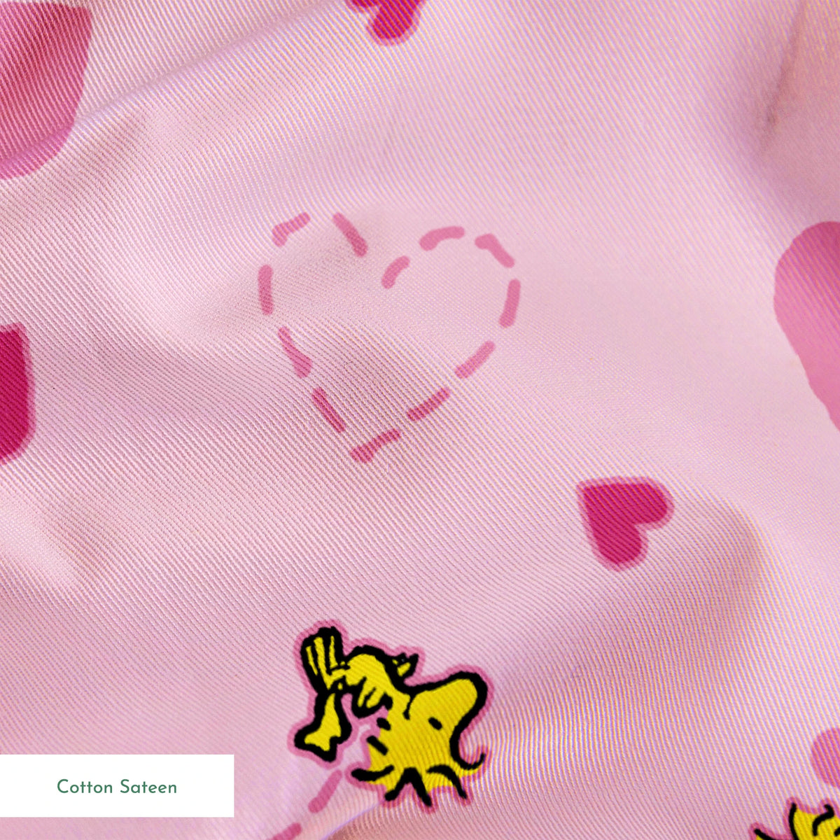 Pink background with hearts and Woodstock pattern, dotted heart outlines and solid pink hearts scattered throughout. springs sateen texture