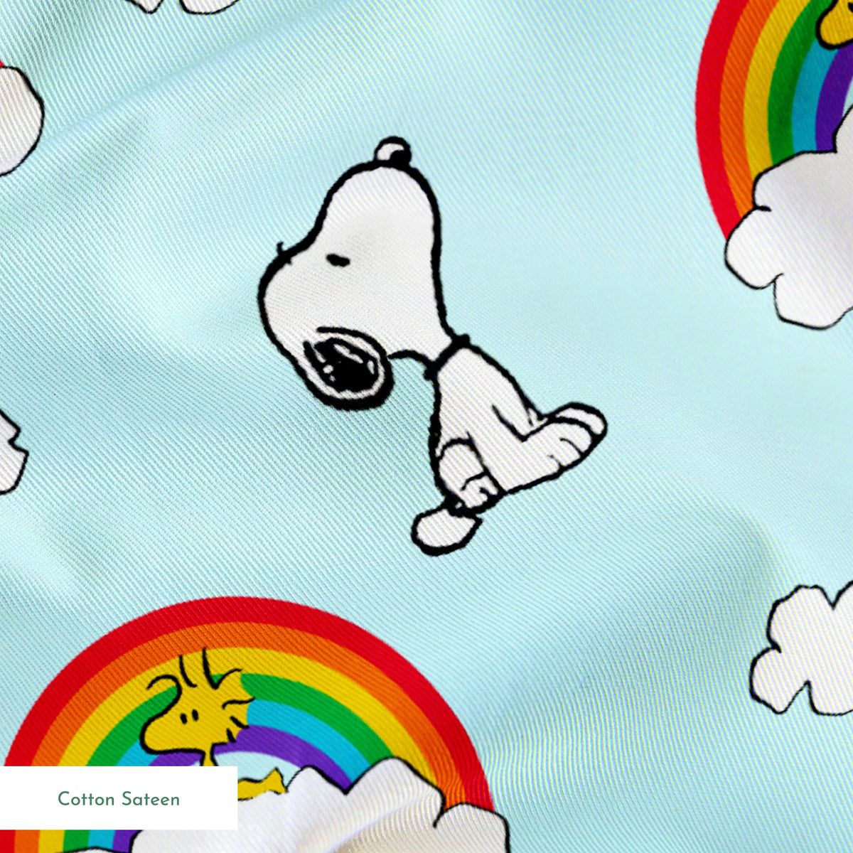 Snoopy and Woodstock characters on light blue background with rainbows, clouds and white fluffy clouds springs sateen texture