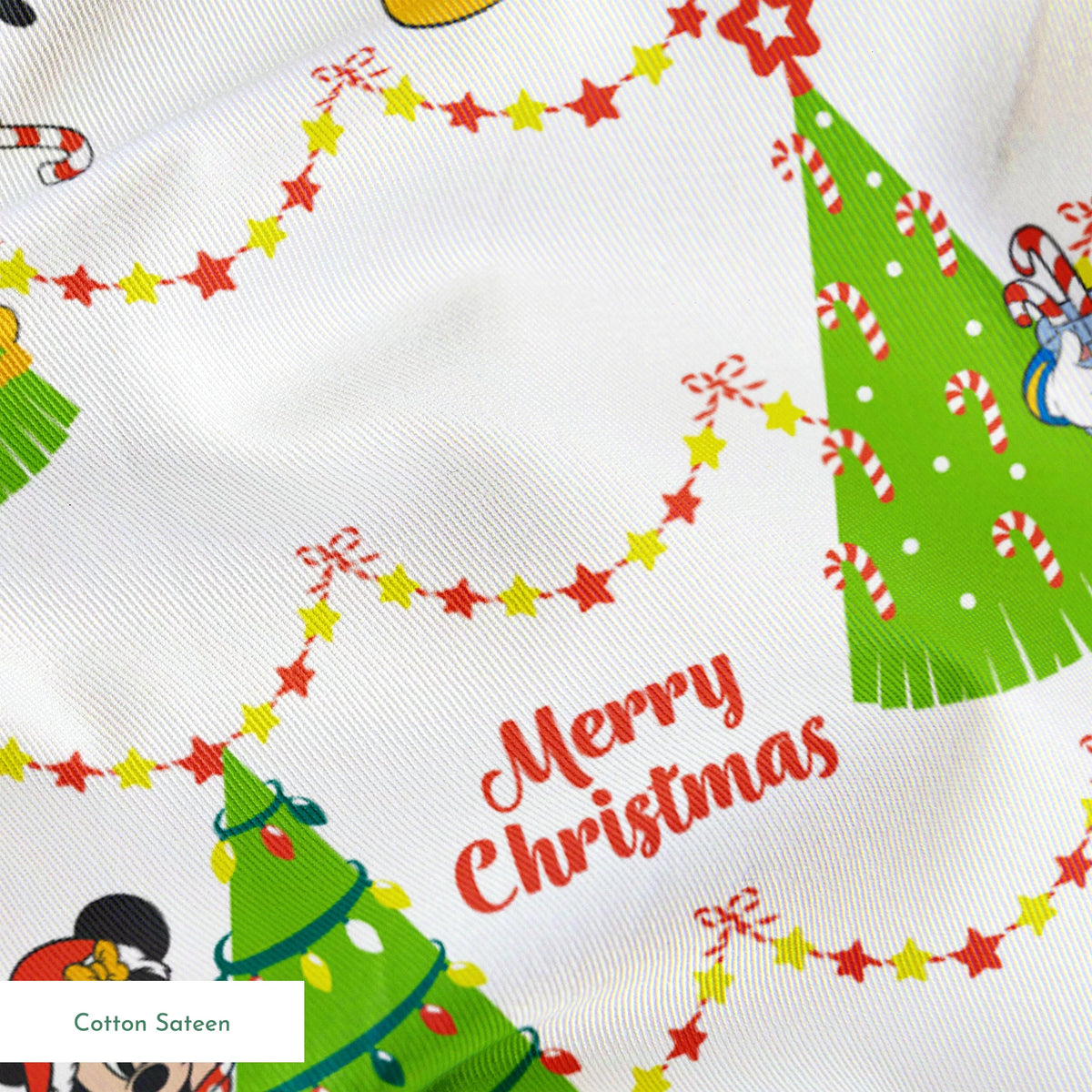 Disney Christmas pattern with Mickey, Minnie, and Donald beside decorated trees with star garland borders springs sateen texture