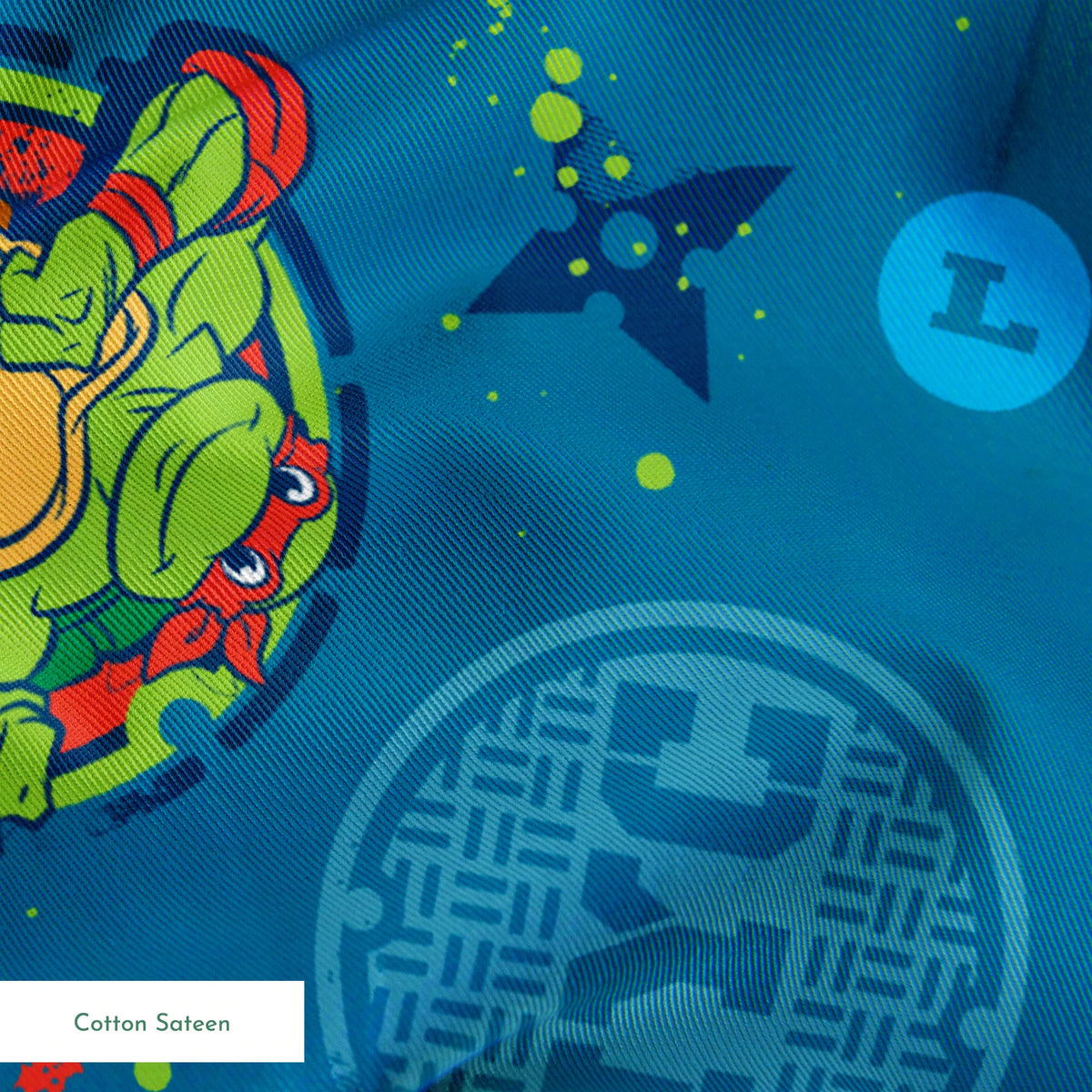 Teenage Mutant Ninja Turtles in circular medallions on teal background with subtle geometric patterns springs sateen texture