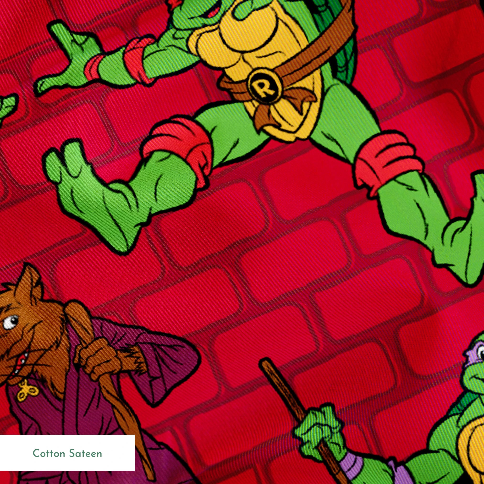 Teenage Mutant Ninja Turtles pattern on red background with green turtle characters in action poses springs sateen texture