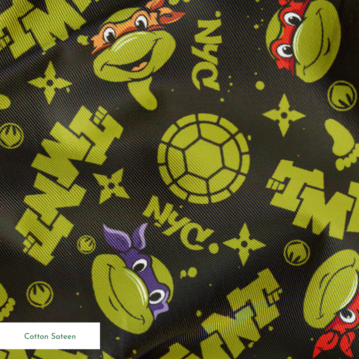 Pattern of Teenage Mutant Ninja Turtles with "TMNT" text on dark background springs sateen texture