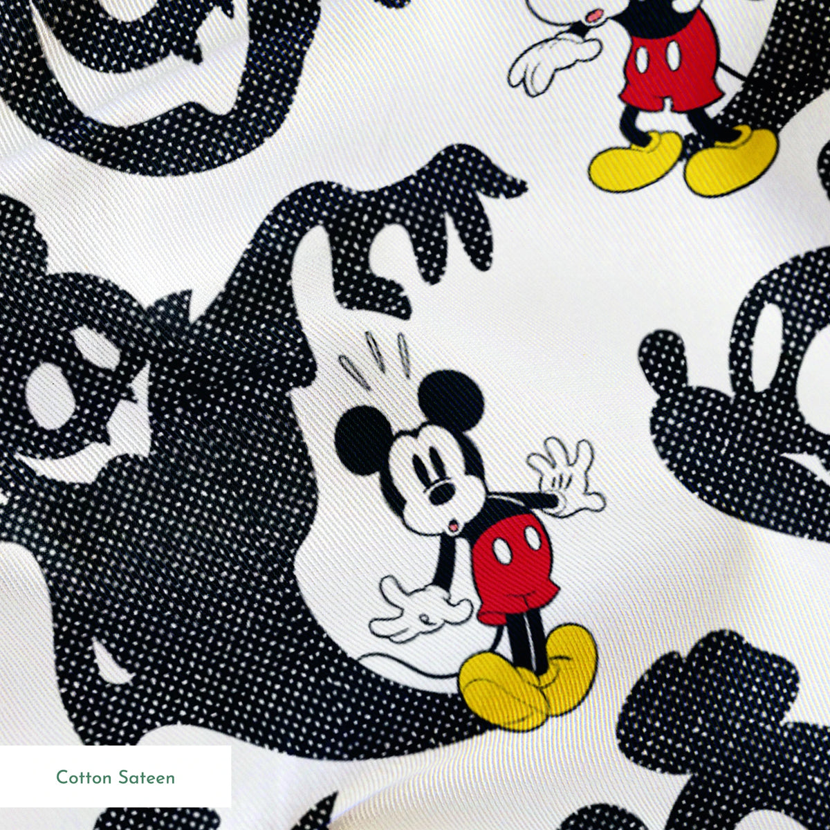 Mickey Mouse pattern with black ghost silhouettes on white background springs sateen texture