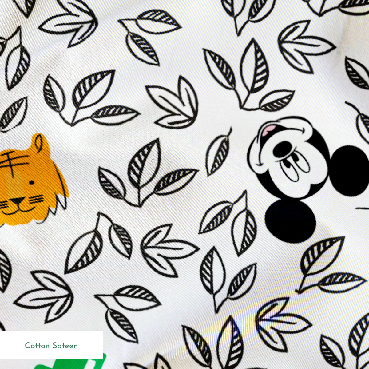 Pattern of cartoon Mickey Mouse silhouettes with yellow honeycomb, green bamboo, and black and white leaves springs sateen texture