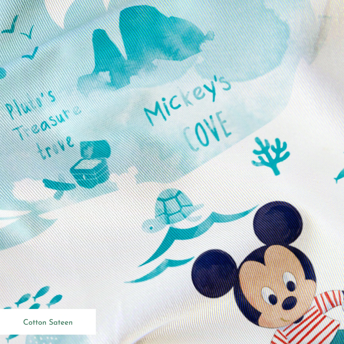Cartoon Mickey Mouse pattern with turquoise ocean elements, sharks, waves, and "Safari" text springs sateen texture