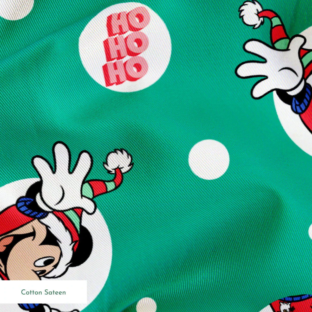 Mickey Mouse in Santa hats on green polka dot background with "Ho Ho Ho" text springs sateen texture