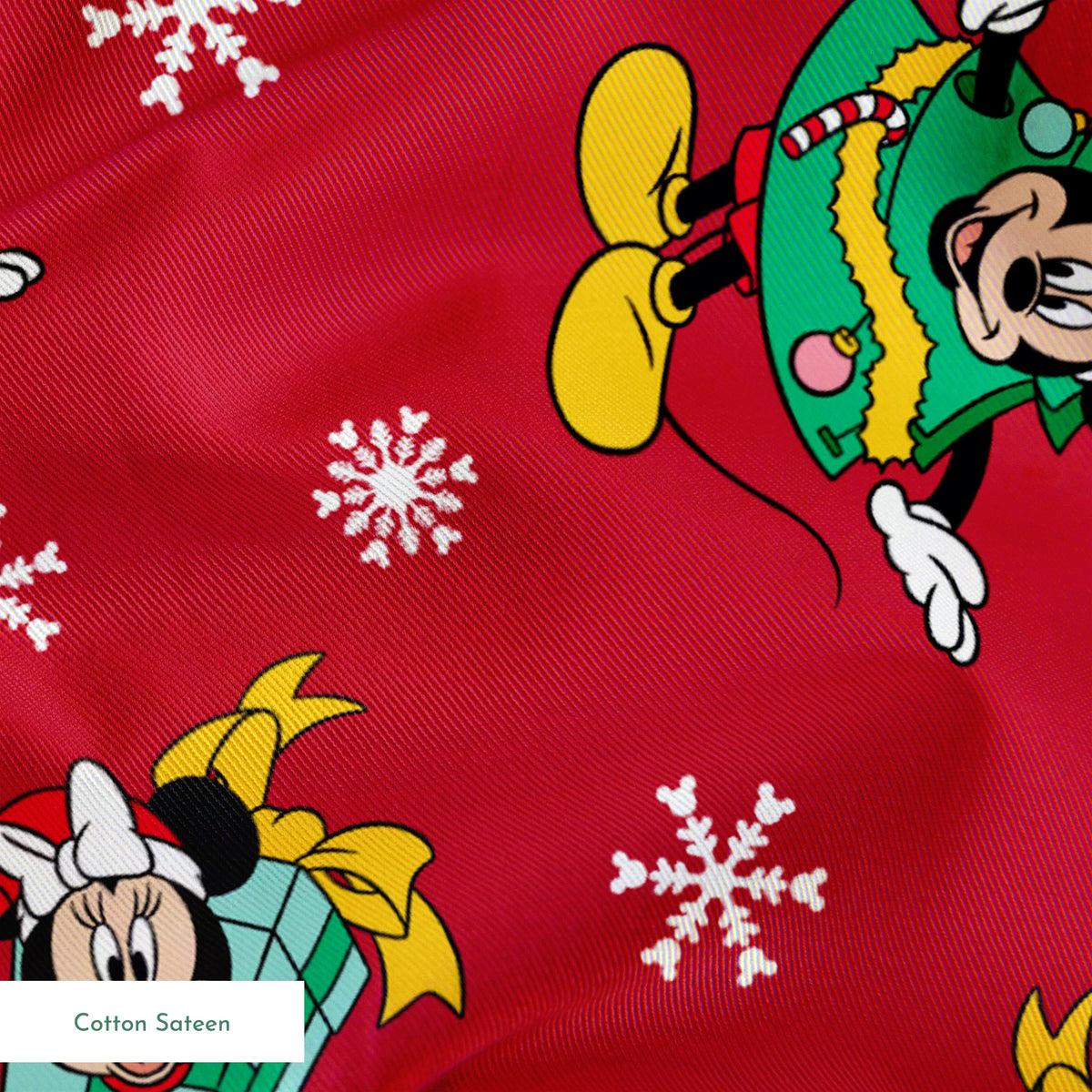 Disney characters in holiday outfits on red background with white snowflakes springs sateen texture