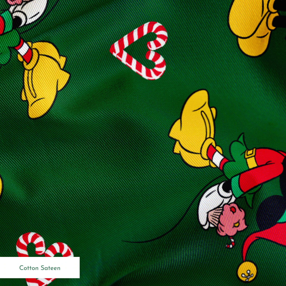 Festive Mickey Mouse pattern with candy canes on green background springs sateen texture
