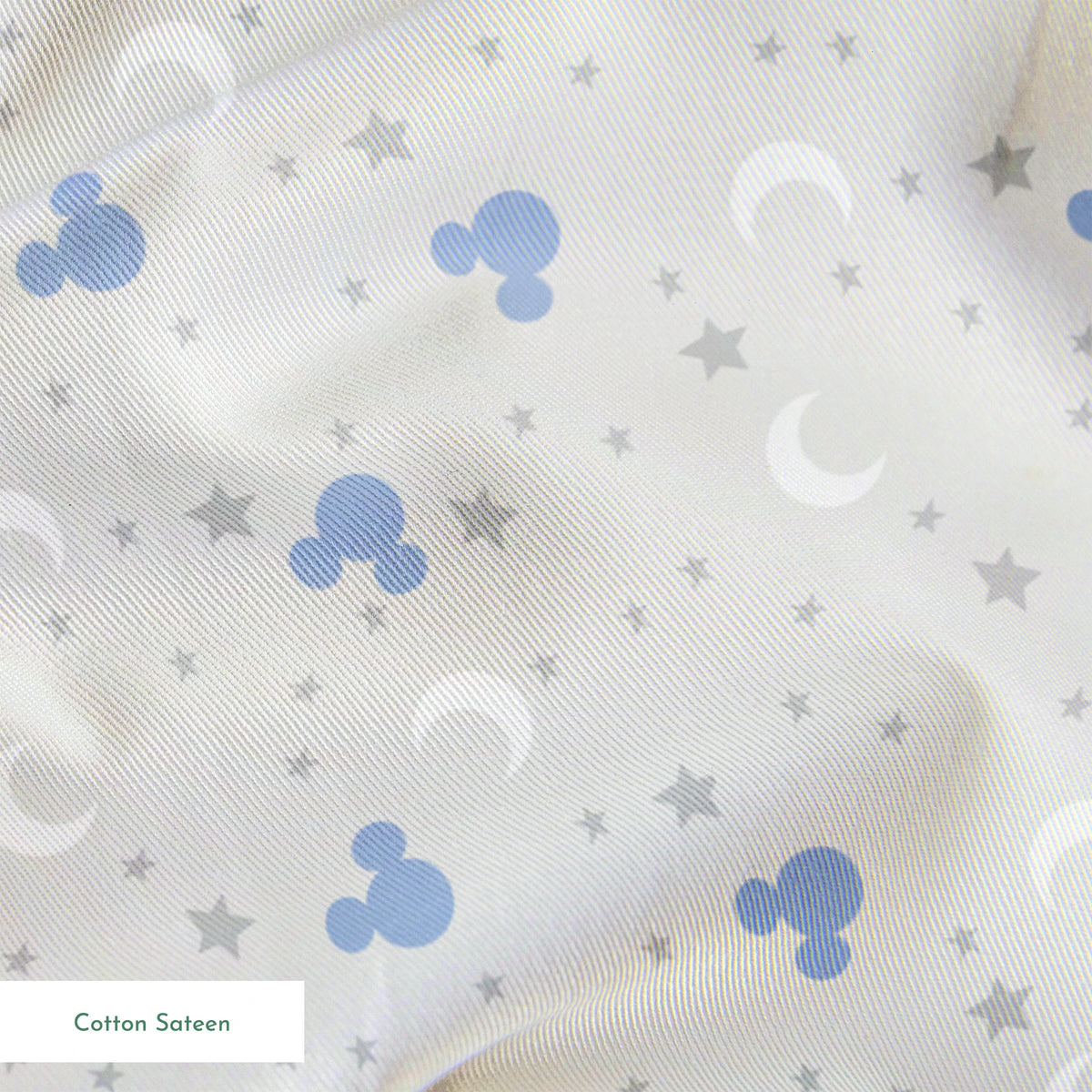 Blue Mickey Mouse silhouettes with white moons and gray stars on light gray background springs sateen texture