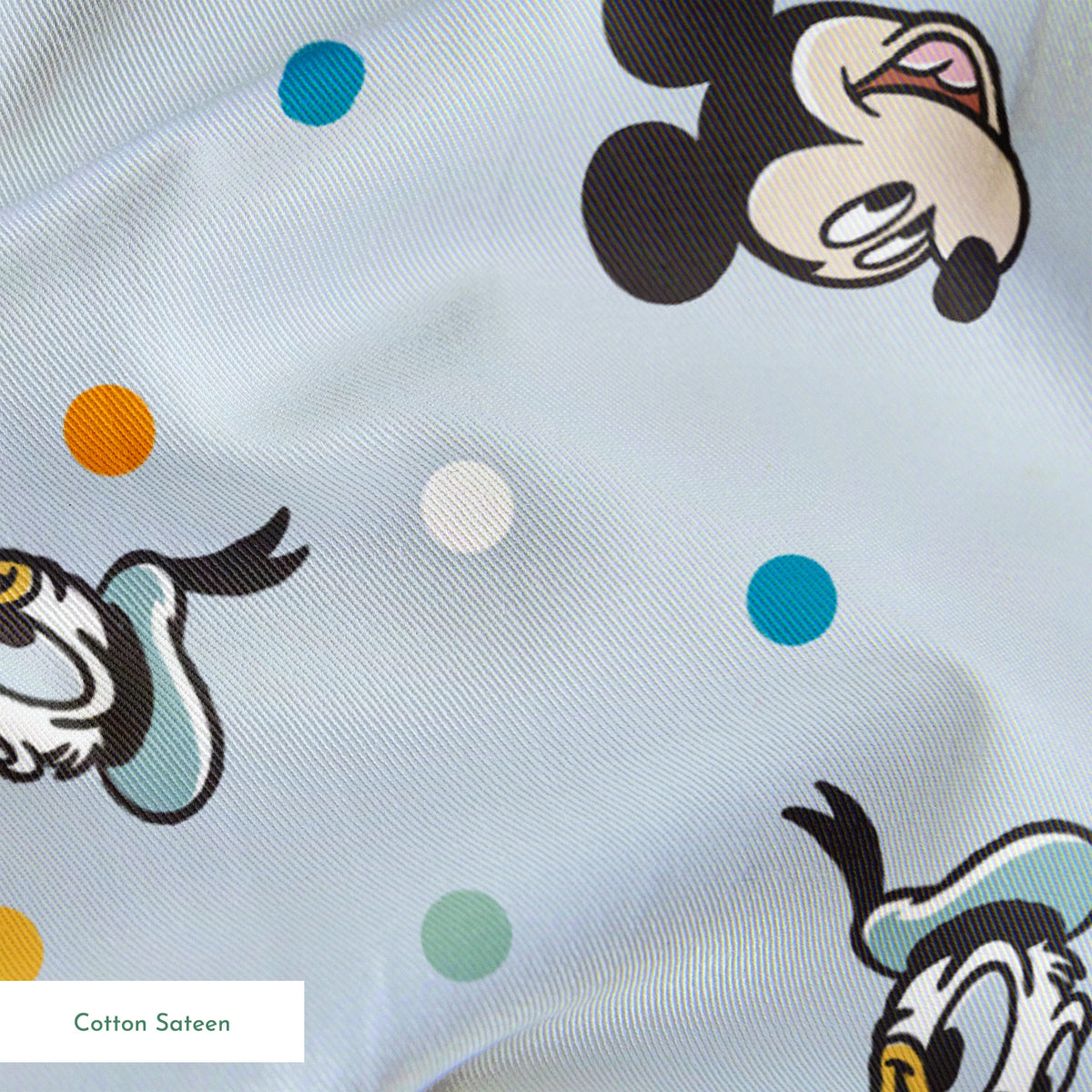 Disney character pattern with Mickey Mouse and Donald Duck heads scattered on light blue background with colorful polka dots springs sateen texture
