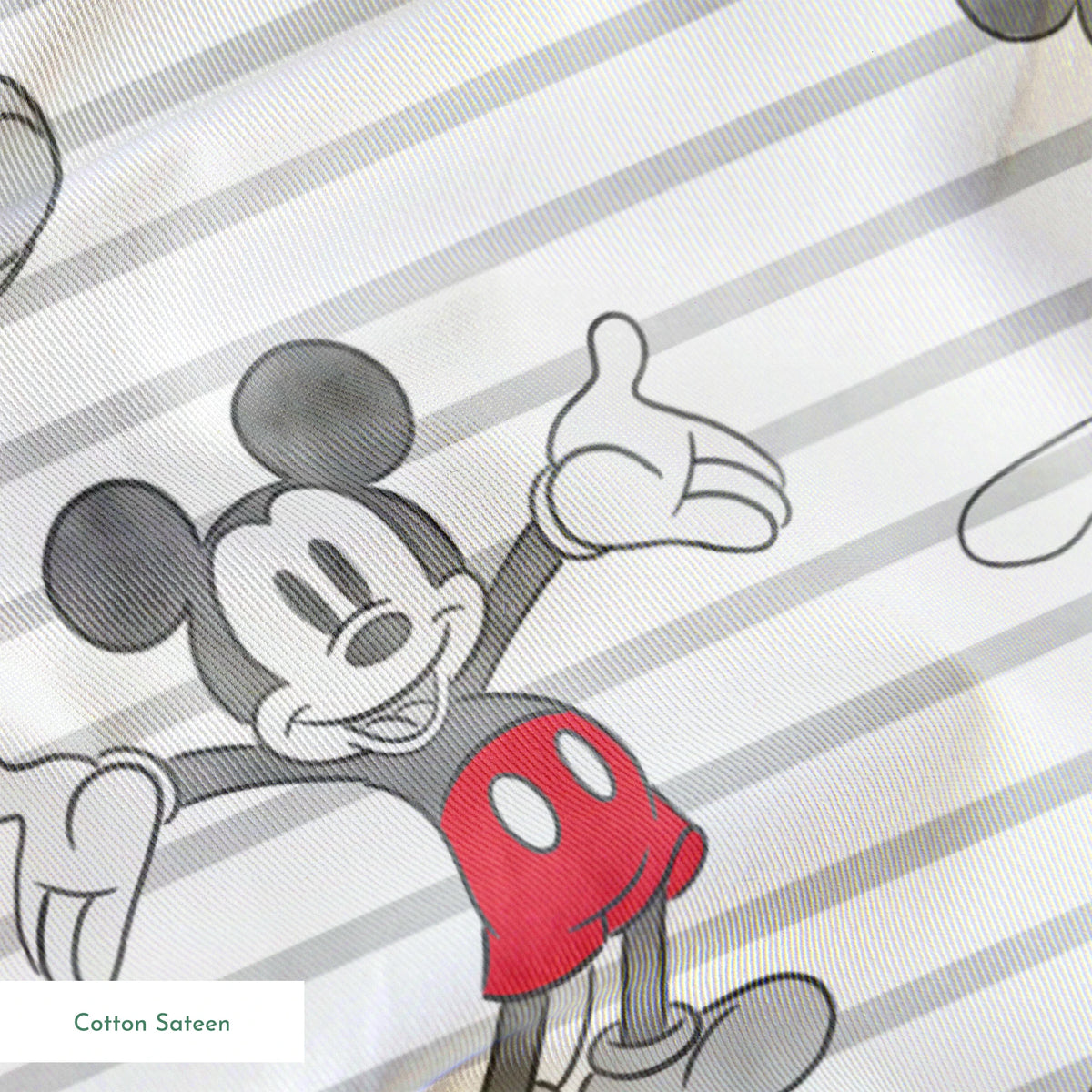 Mickey Mouse cartoon characters in various poses on gray and white striped background springs sateen texture