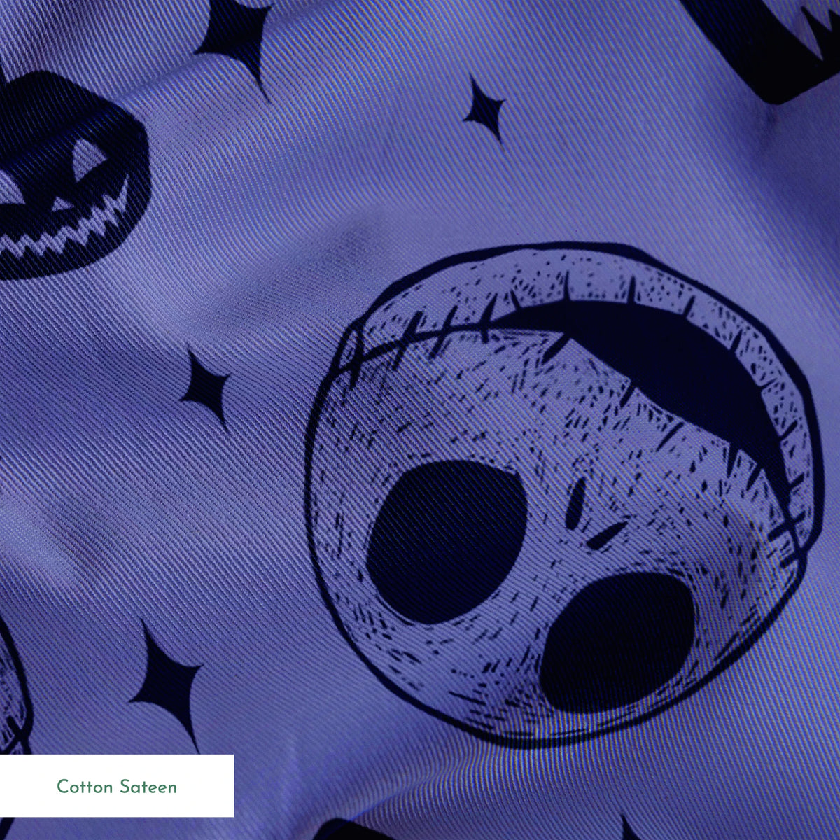 Nightmare Before Christmas skull and pumpkin pattern on purple background with black star shapes springs sateen texture