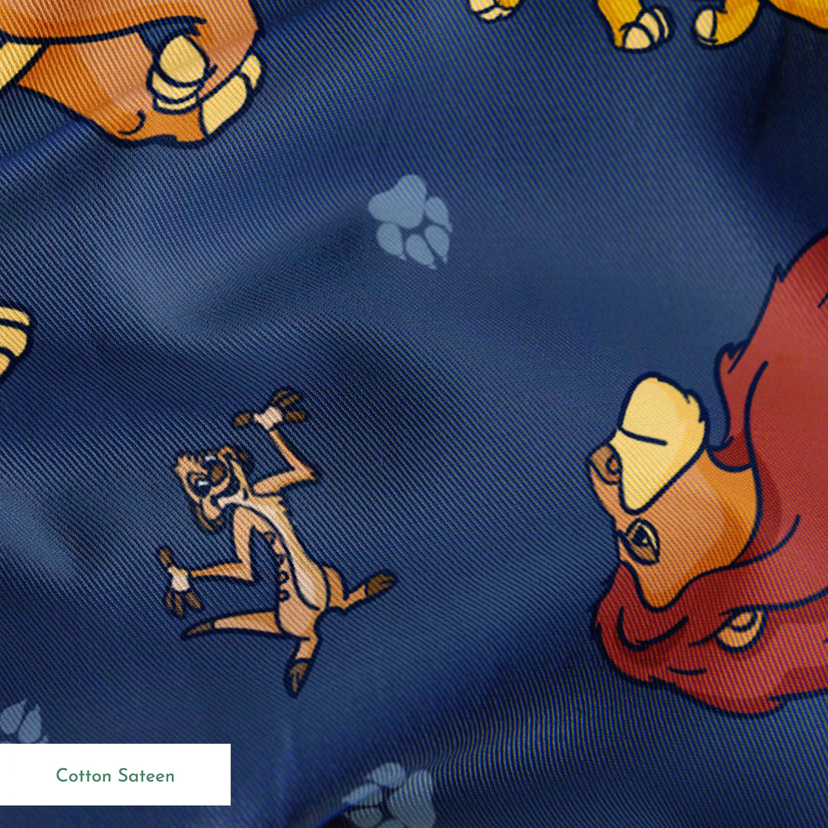 Colorful cartoon lions and characters from The Lion King scattered on dark blue background with paw prints springs sateen texture