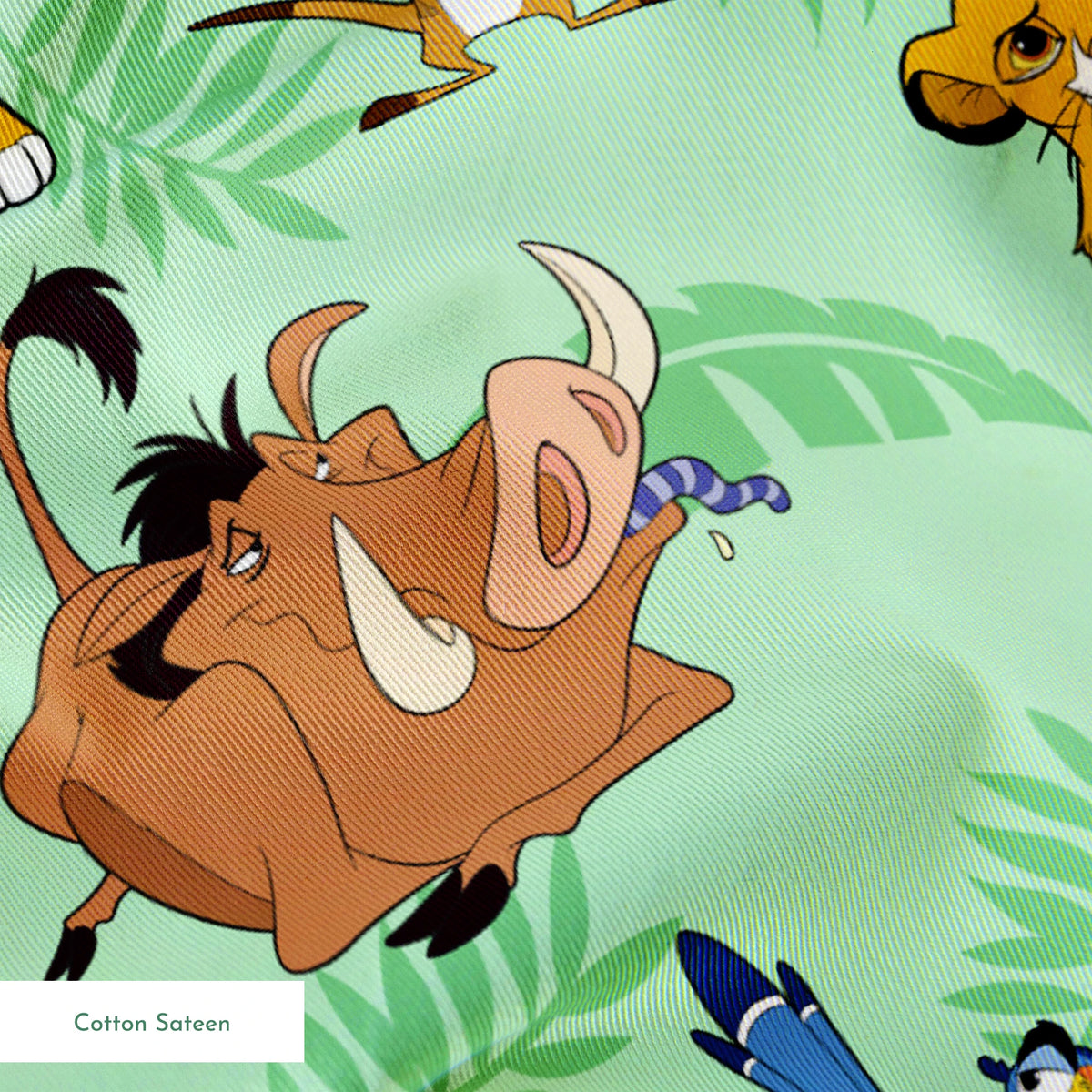 A repeating pattern of Lion King characters - Simba, Timon, Pumbaa, and Zazu on a light green leafy background. springs sateen texture