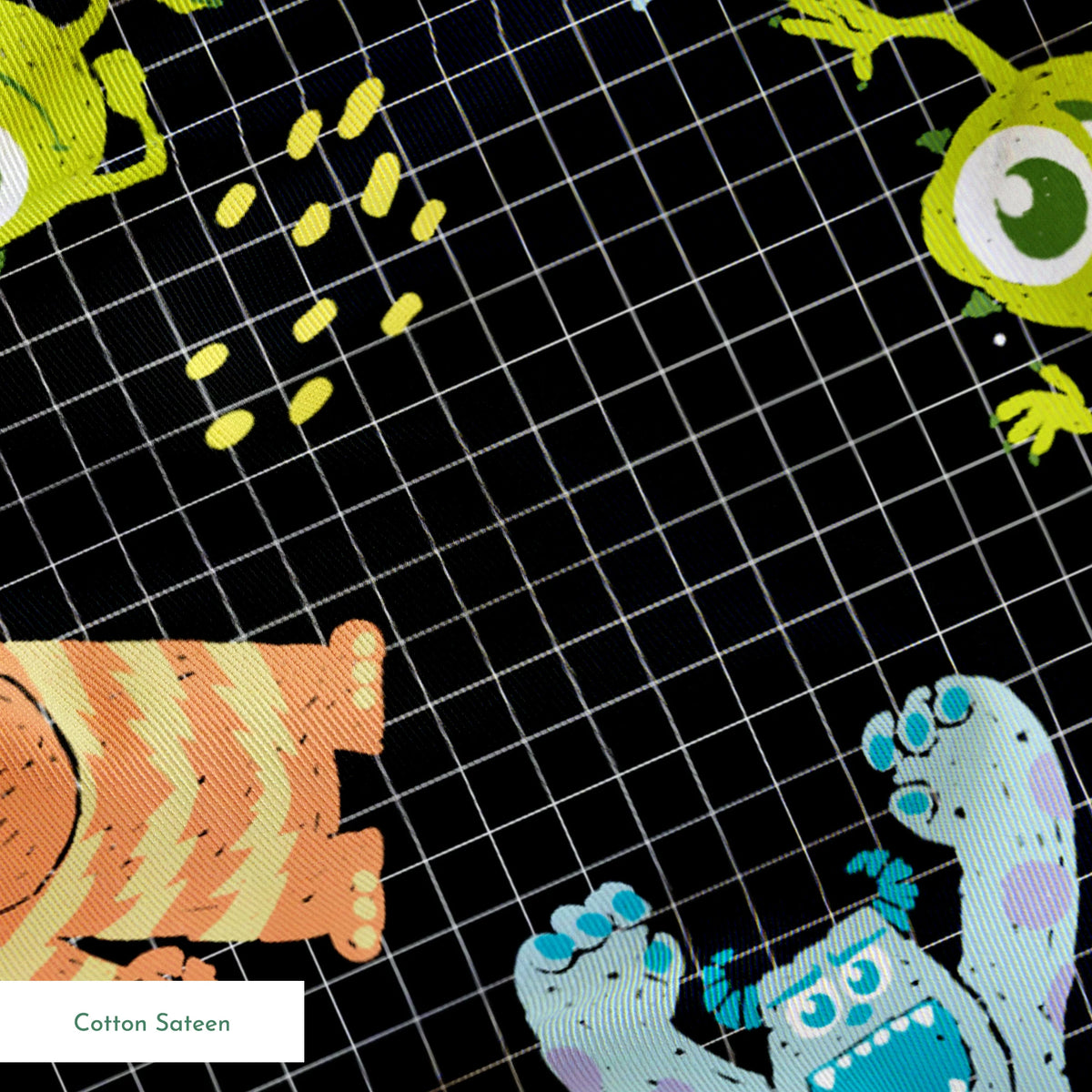 Monsters Inc pattern with Sulley, Mike, & friends on black grid background springs sateen texture