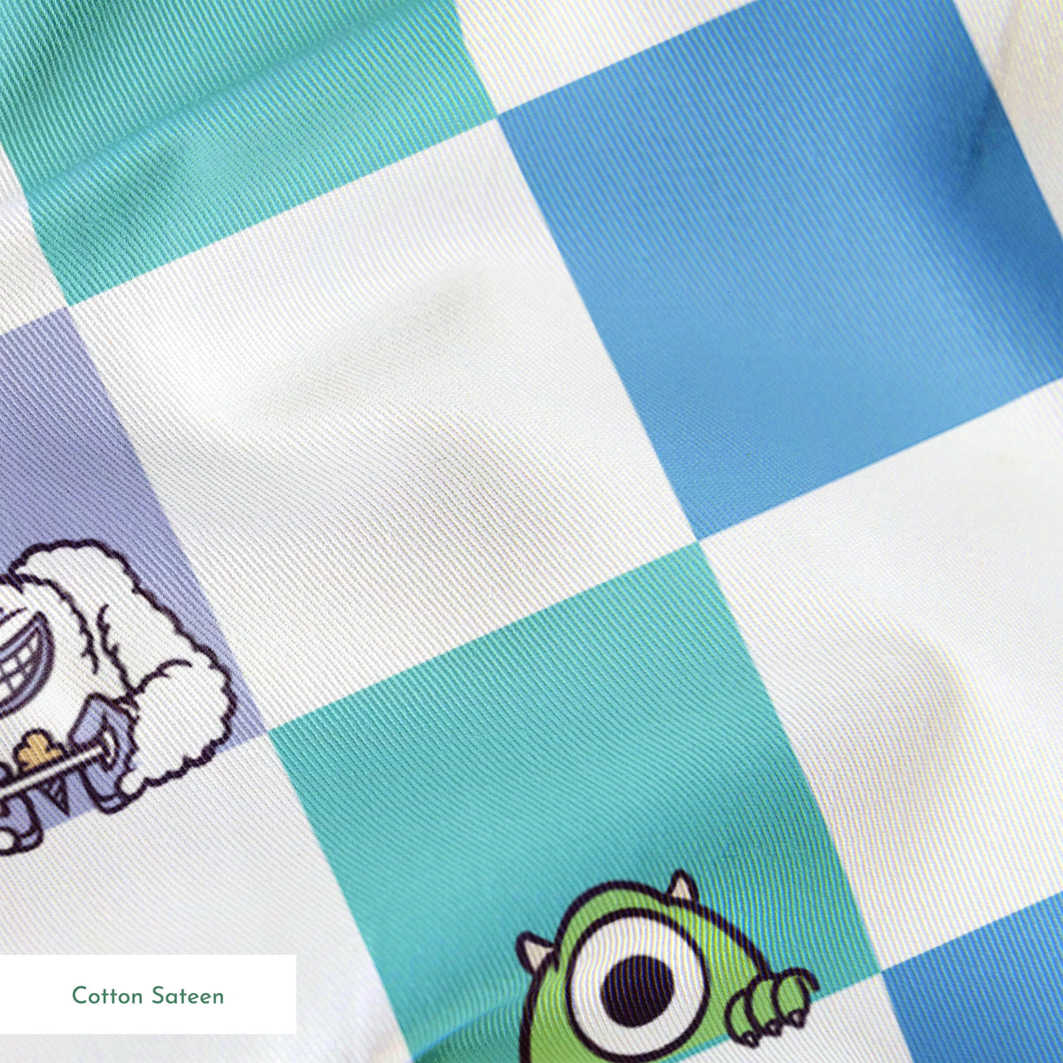 Monsters Inc characters on a checkered pattern of white, mint green, light purple, and blue squares springs sateen texture