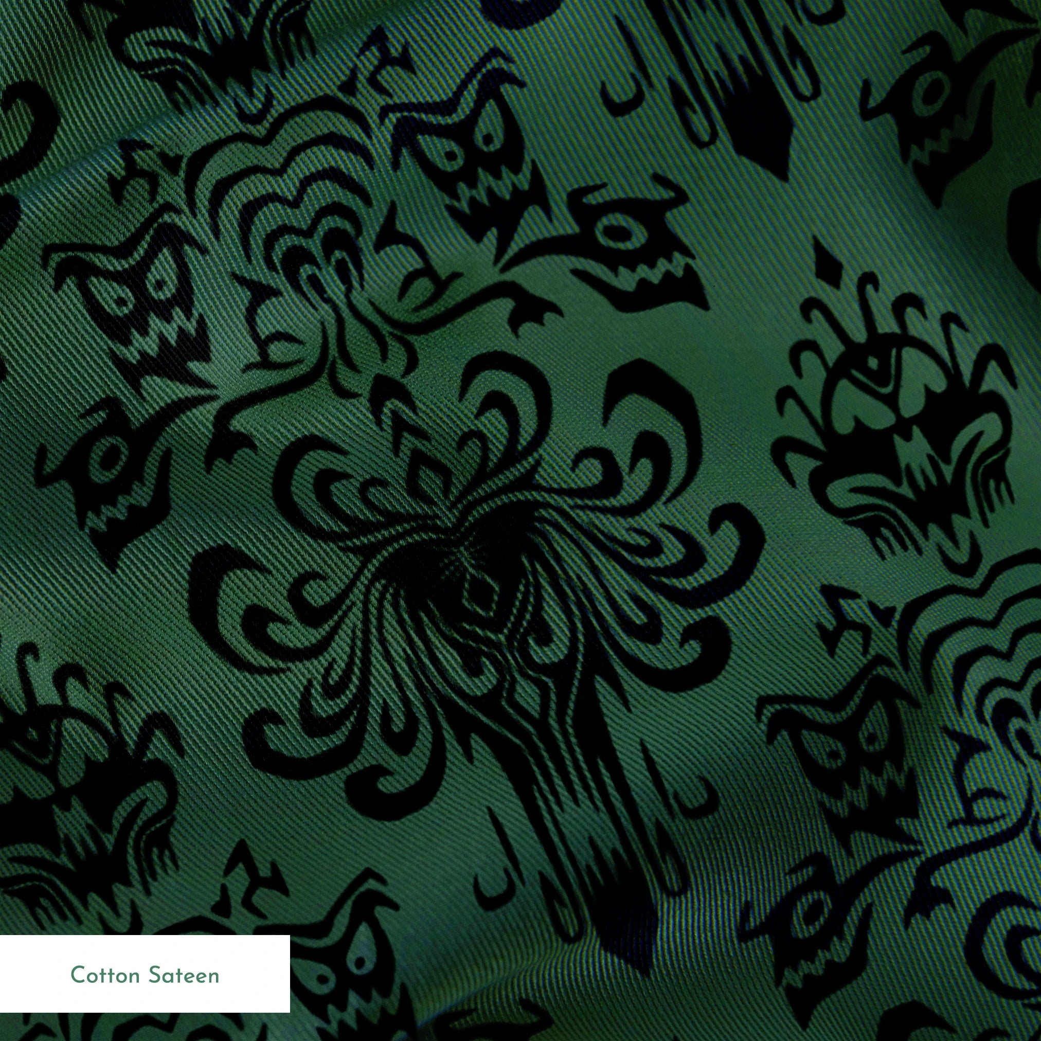 The image shows an elegant Victorian or Gothic-style damask pattern in black against a dark green background. The repeating ornate design features intricate scrollwork, flourishes, and symmetrical decorative elements arranged in a traditional wallpaper or textile pattern style. springs sateen texture