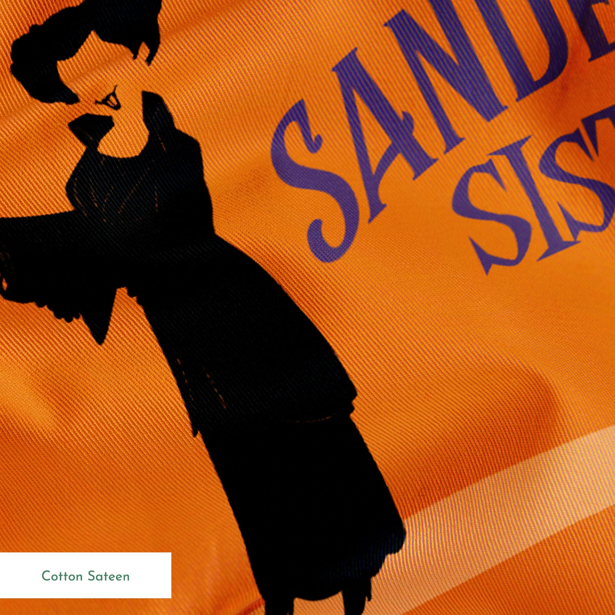 Orange background with silhouettes of witches in black robes and text "Sanderson Sisters" and "Salem's" in blue lettering springs sateen texture
