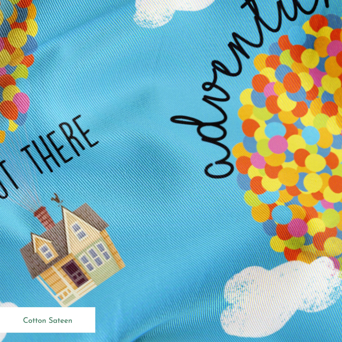Colorful Up-inspired balloon houses floating in blue sky with text "Adventure is out there" repeating in pattern springs sateen texture