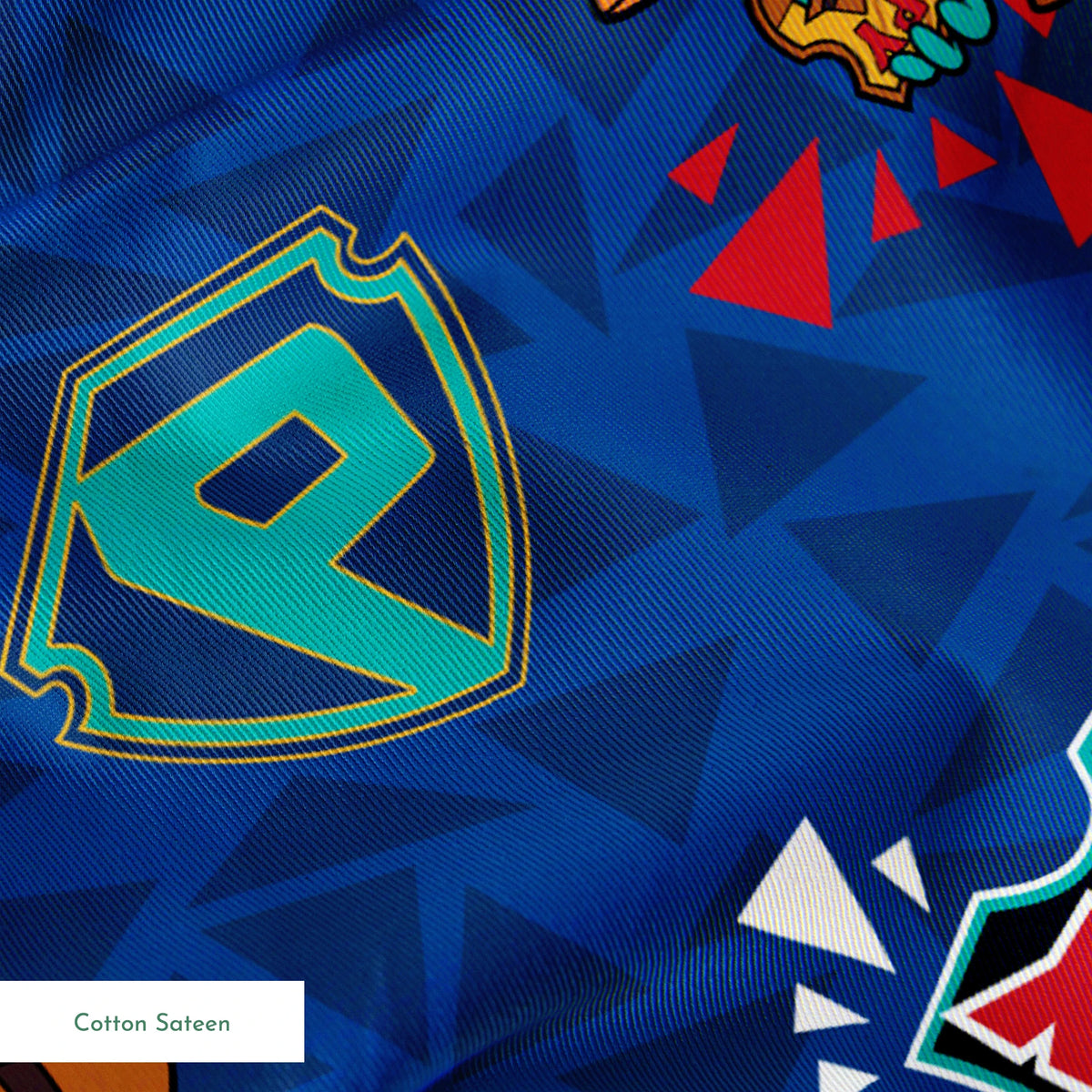 Colorful Perry the Platypus pattern with "SPY" text on blue geometric background springs sateen texture