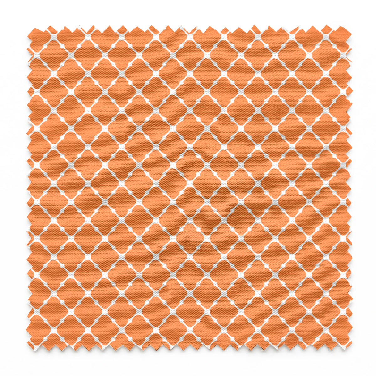 Geometric orange and white pattern with quatrefoil shapes forming a lattice design springs swatch pinked