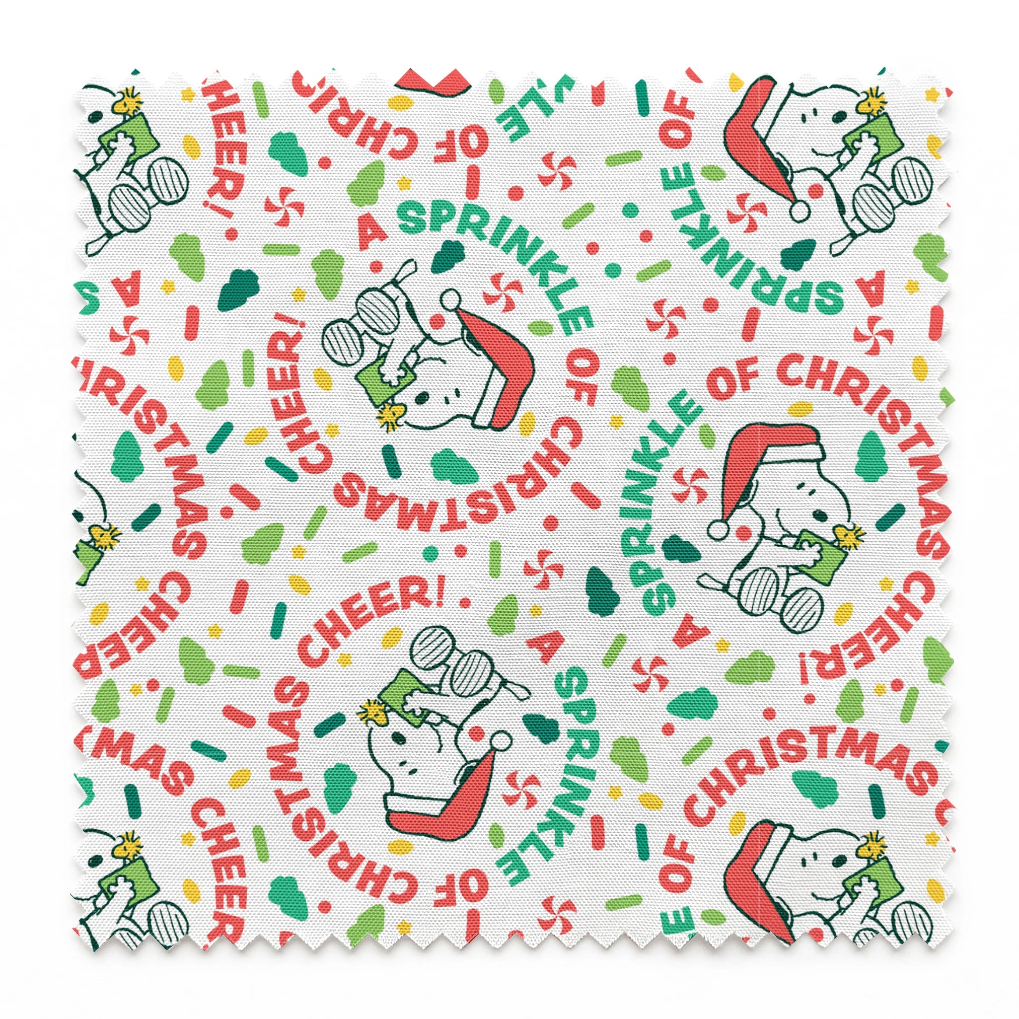 Holiday pattern with Snoopy wearing Santa hat, surrounded by "Merry Christmas", "Cheer", and candy designs on white background springs swatch pinked