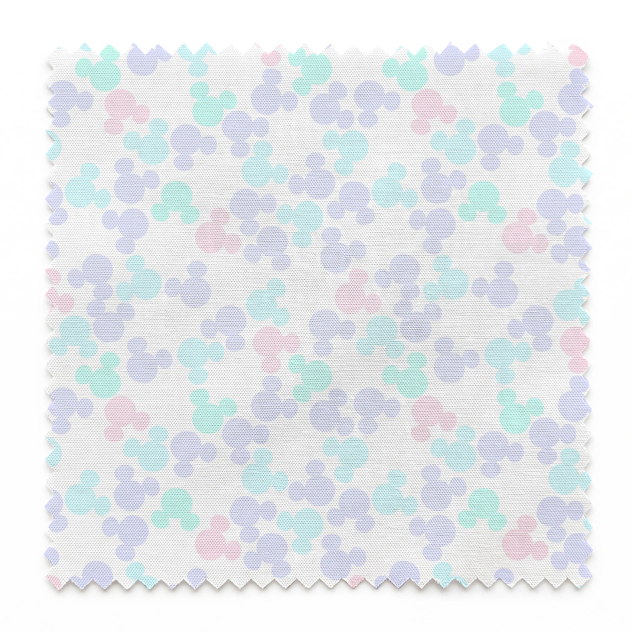 Pastel circular pattern with purple, light blue, green, and pink bubble shapes on white background springs swatch pinked