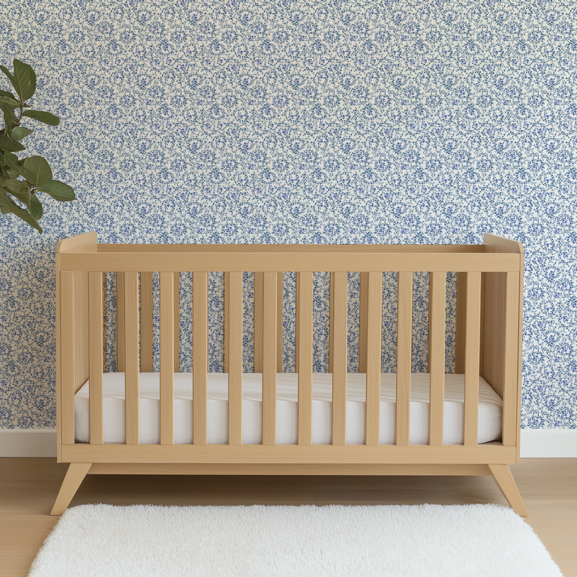 Blue floral motifs interspersed with scroll-like vines on a white background, creating a dense, patterned design. wallpaper crib mockup