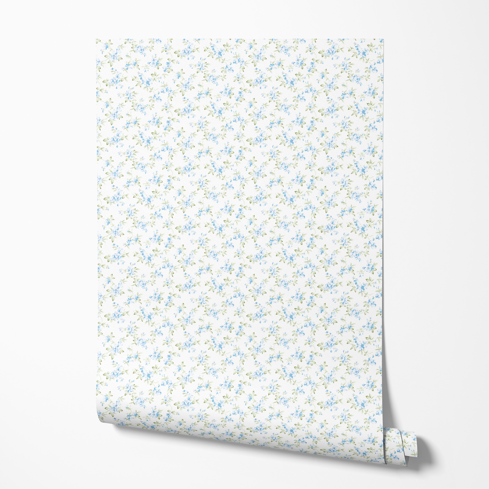 Delicate blue floral pattern with small scattered flowers and green leaves on white background wallpaper roll mockup