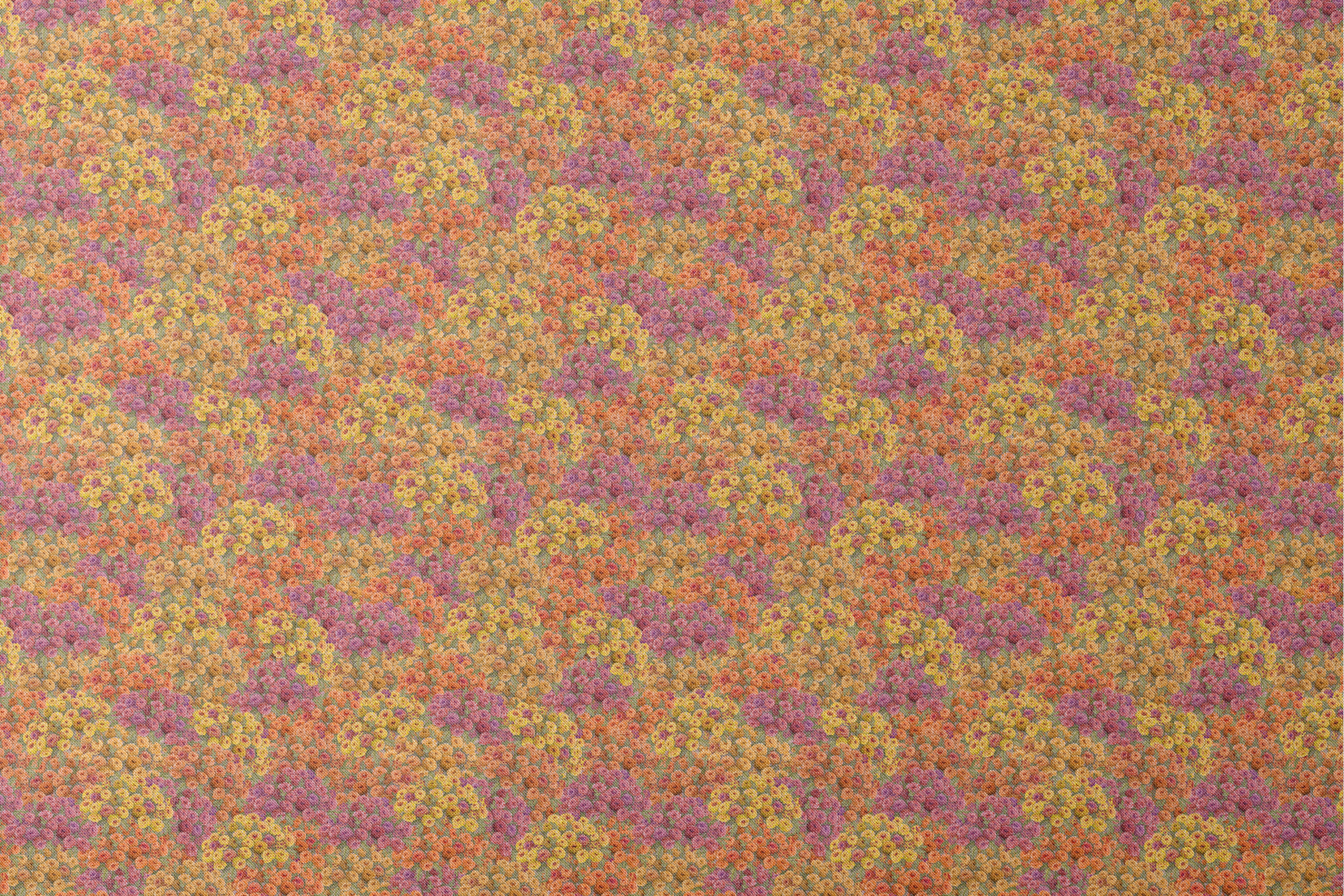 Dense floral fabric featuring orange, gold, pink, and plum zinnias in a packed all-over pattern by Nicole Tamarin. designs flat mockup
