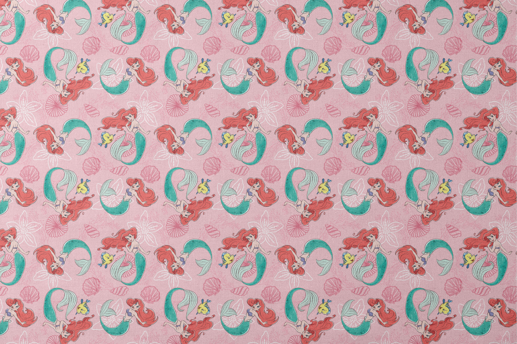 Illustrated pattern of mermaids with red hair and green tails swimming with yellow fish on pink seashell background designs flat mockup