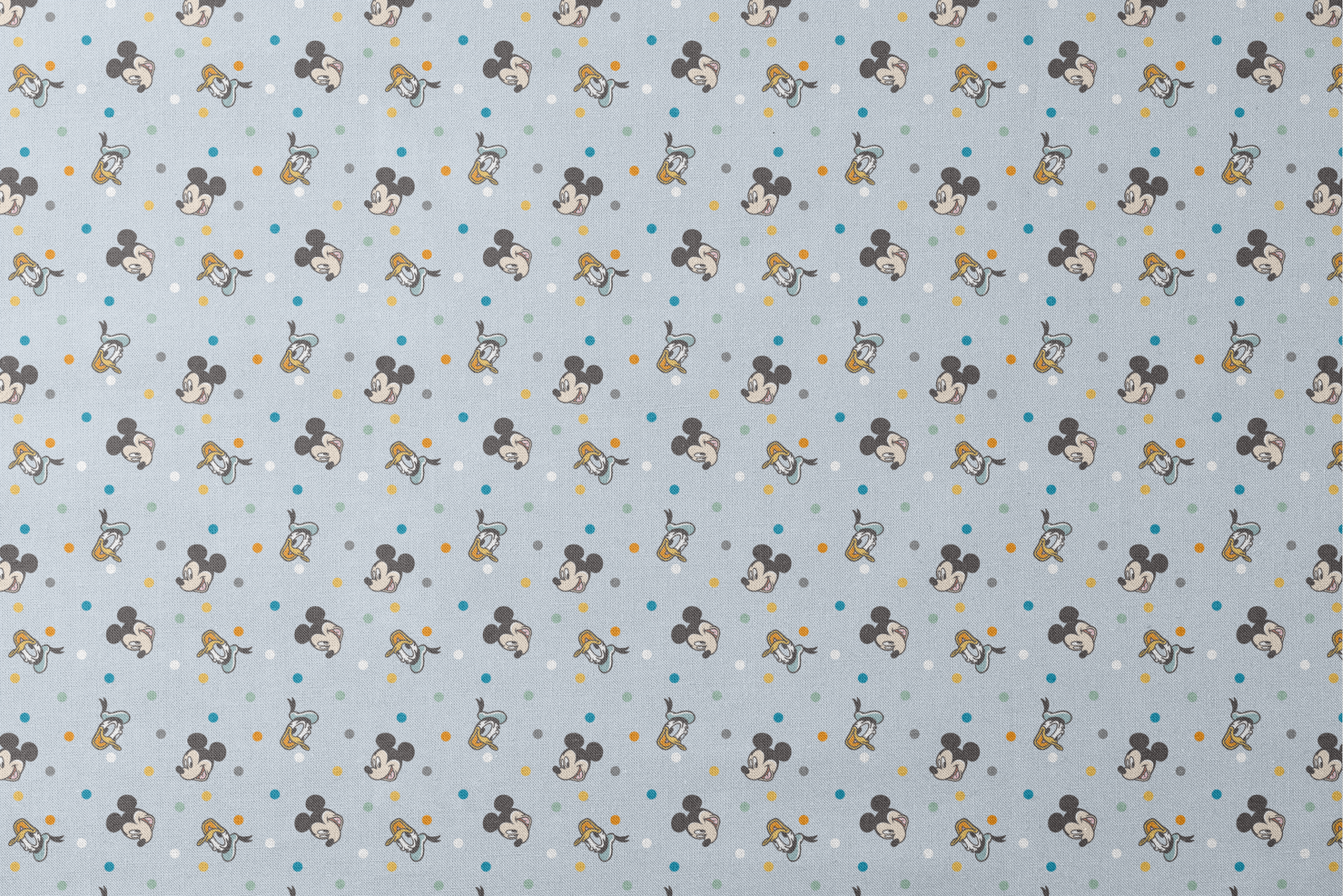 Disney character pattern with Mickey Mouse and Donald Duck heads scattered on light blue background with colorful polka dots designs flat mockup