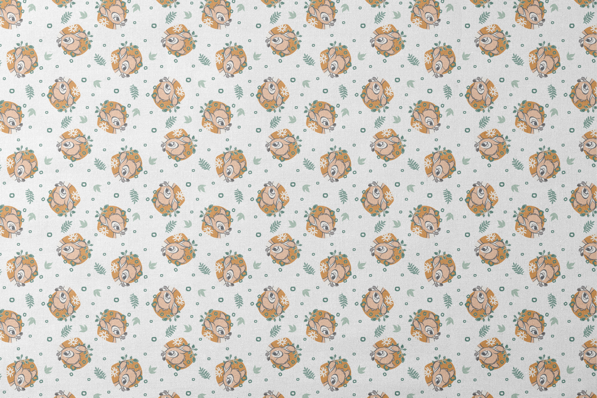 Disney’s Bambi illustrated in golden-orange floral medallions with green leaves and scattered geometric accents on a white background. designs flat mockup