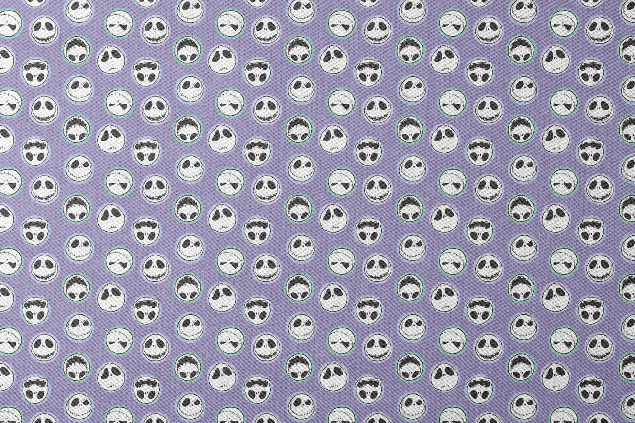 Repeating skull faces with stitched mouths and large eyes on purple background in cartoon style designs flat mockup