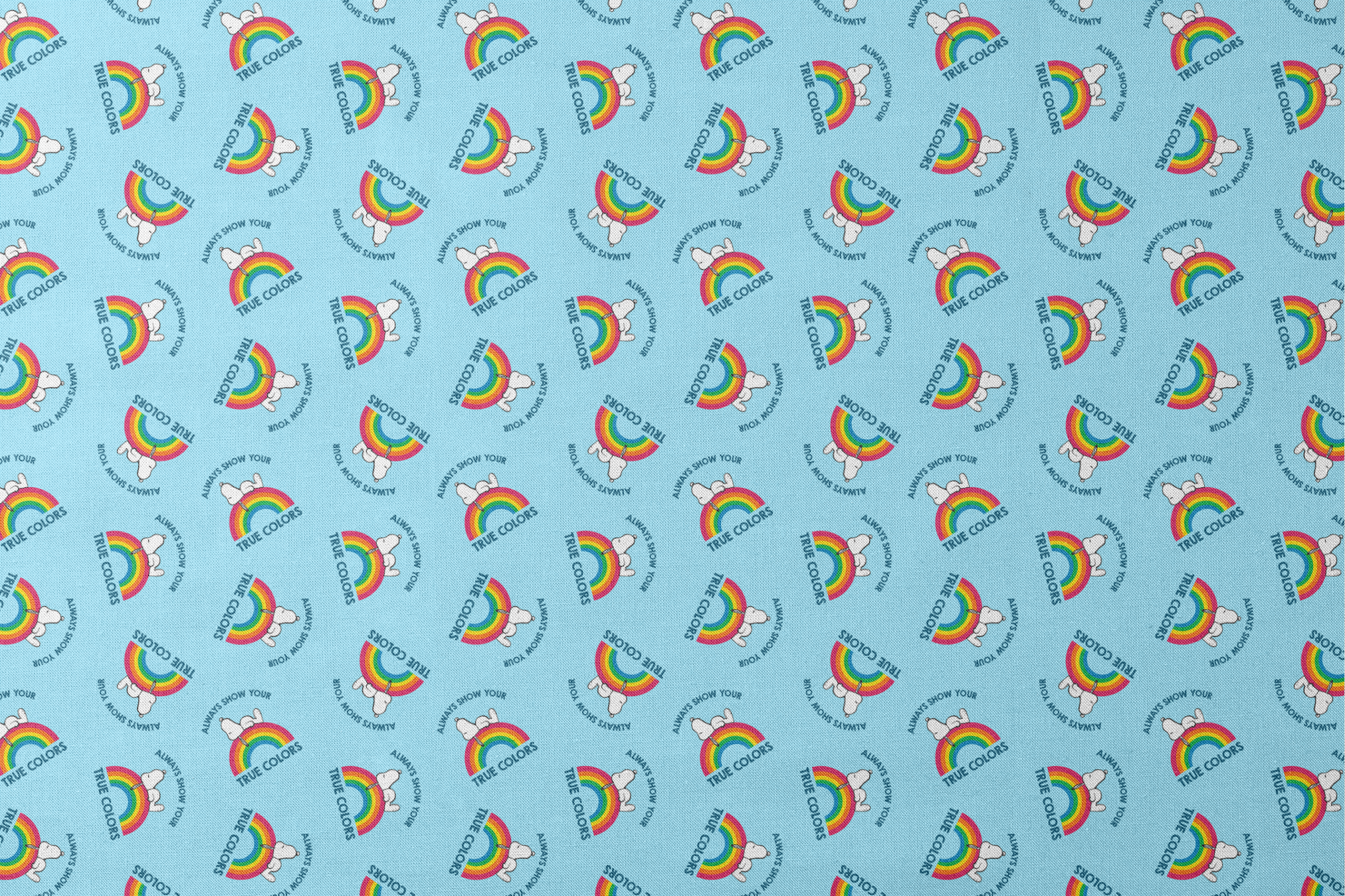Rainbow Snoopy pattern on light blue background with white clouds and "TRUE COLORS" and "ALWAYS SHOW YOUR" text repeated throughout design designs flat mockup