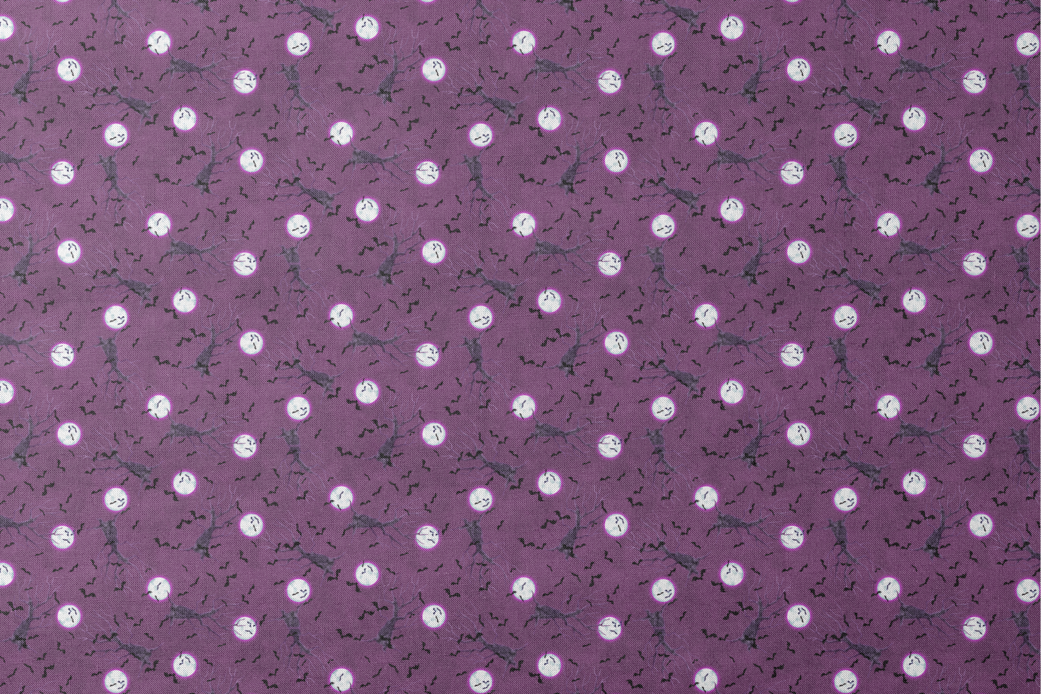Halloween fabric design with spooky trees, bats, and glowing full moons on a purple background, illustrated by Nicole Tamarin. designs flat mockup