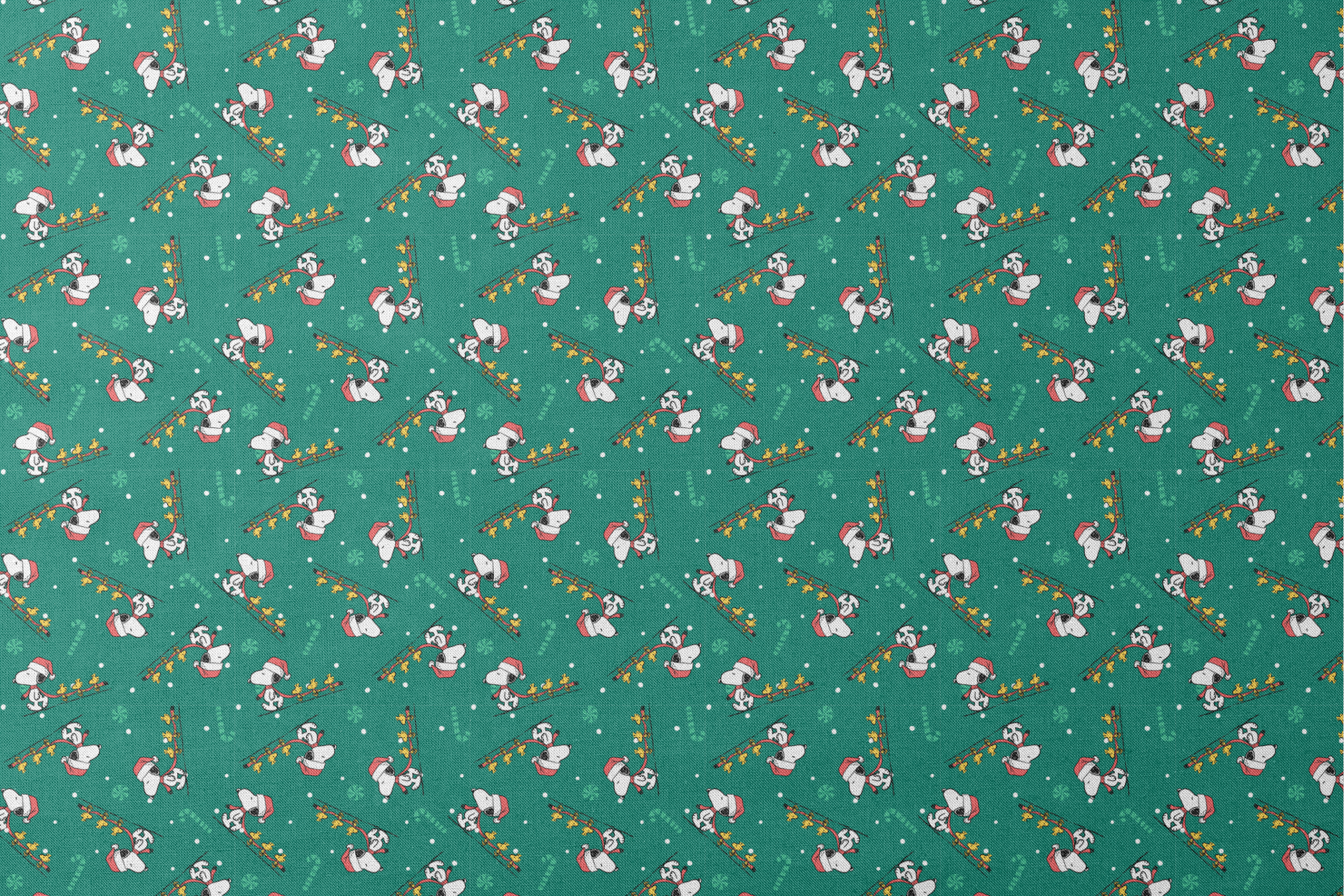 Holiday pattern with Snoopy in Santa hats pulling sleds of stars on green background with candy canes and snowflakes designs flat mockup