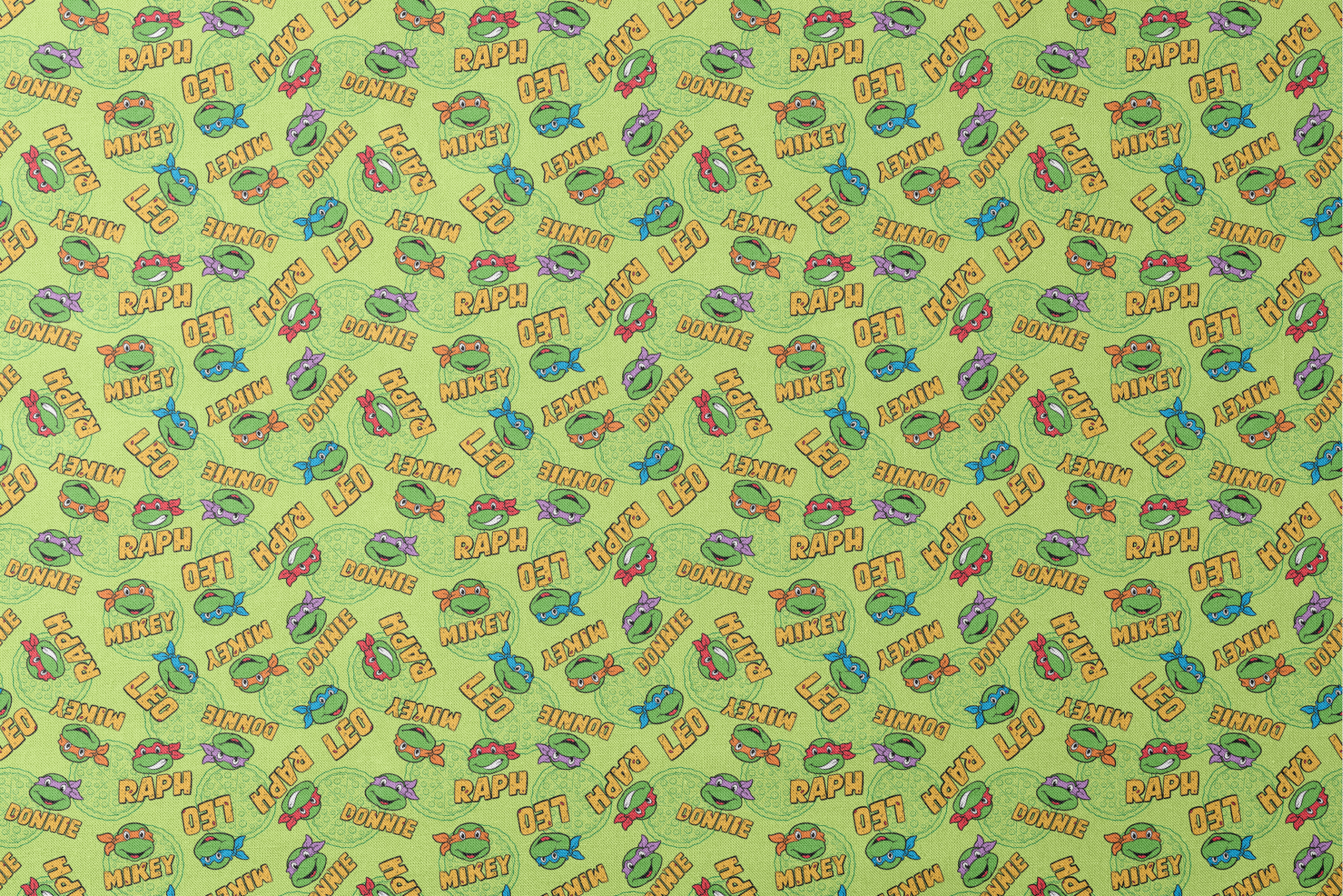 Teenage Mutant Ninja Turtles pattern with cartoon faces, names, and colorful masks on green background designs flat mockup