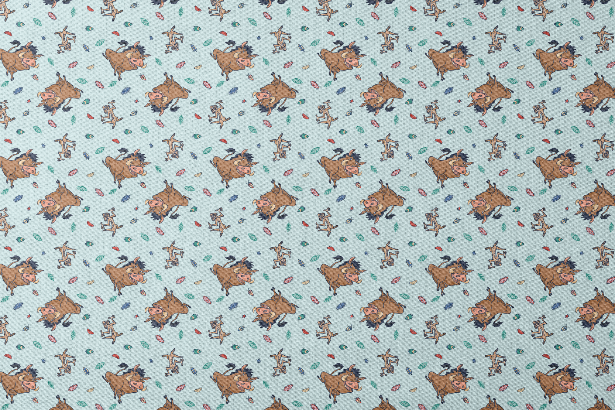 Lion King characters and colorful leaves scattered on light blue background in playful pattern designs flat mockup