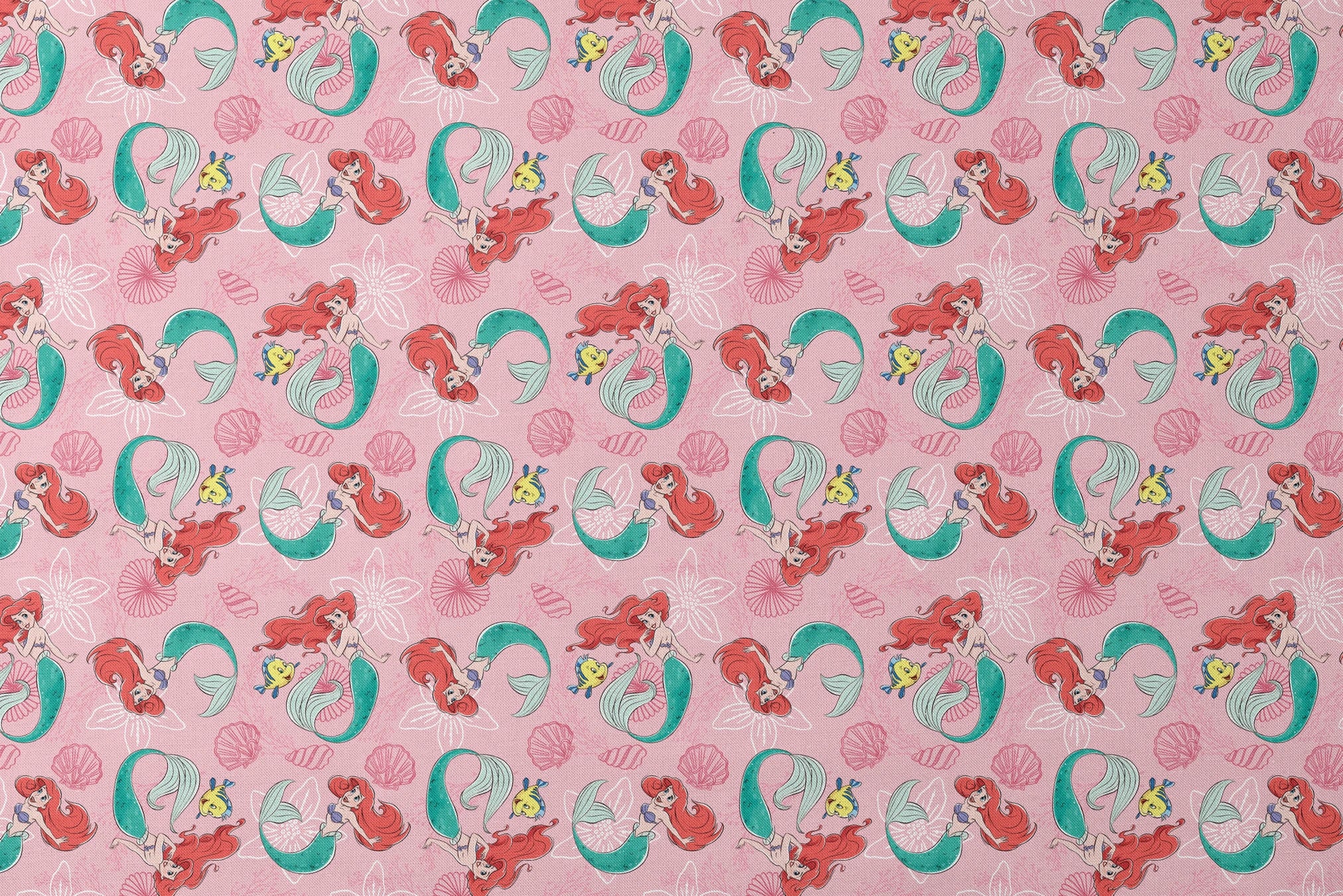 Illustrated pattern of mermaids with red hair and green tails swimming with yellow fish on pink seashell background designs flat mockup