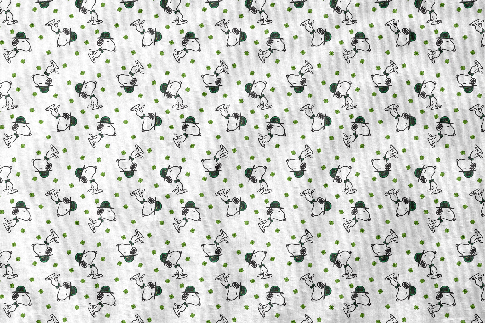 Cartoon Snoopy wearing green hat with shamrocks scattered across white background designs flat mockup